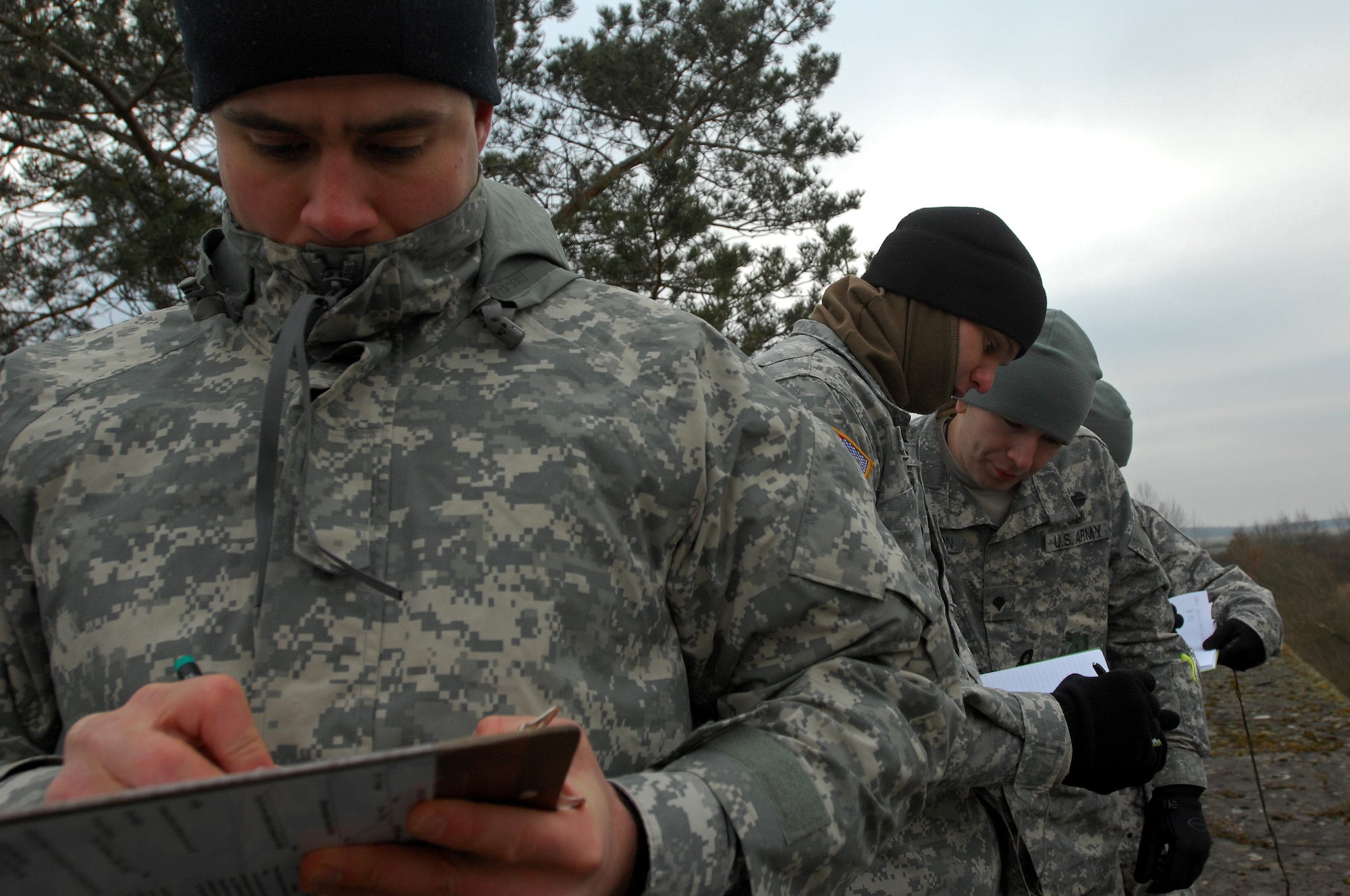 Army Sgt. Albert Dyk, Joint Fire observer, and other JFOs use maps and grids to plot coordinates to call in an air strike while participating in a JFO and Joint Terminal Air Controllers exercise, Jan. 29, 2009, in Southern France. Army JFOs and Air Force JTAC students worked together during the exercise to reach mission success. (U.S. Air Force photo by Airman 1st Class Kenny Holston)