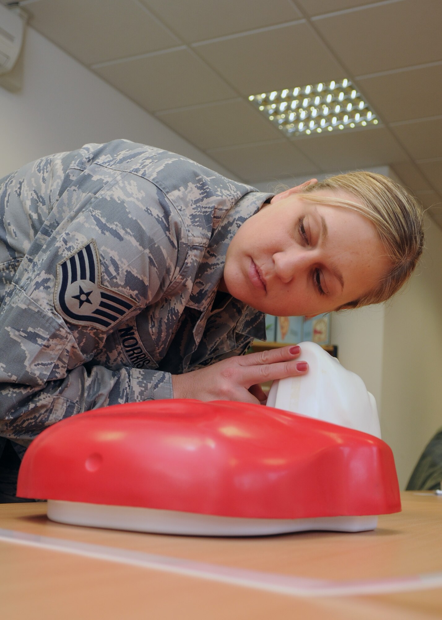 SPANGDAHLEM AIR BASE, Germany -- Staff Sgt. Heather Norris, 52nd Fighter Wing Public Affairs Office, checks a simulated victim for signs of breathing, Jan. 30, during the Heartsaver Automated External Defibrillator course held at the Health and Wellness Center. (U.S. Air Force photo by Airman Staci Miller)