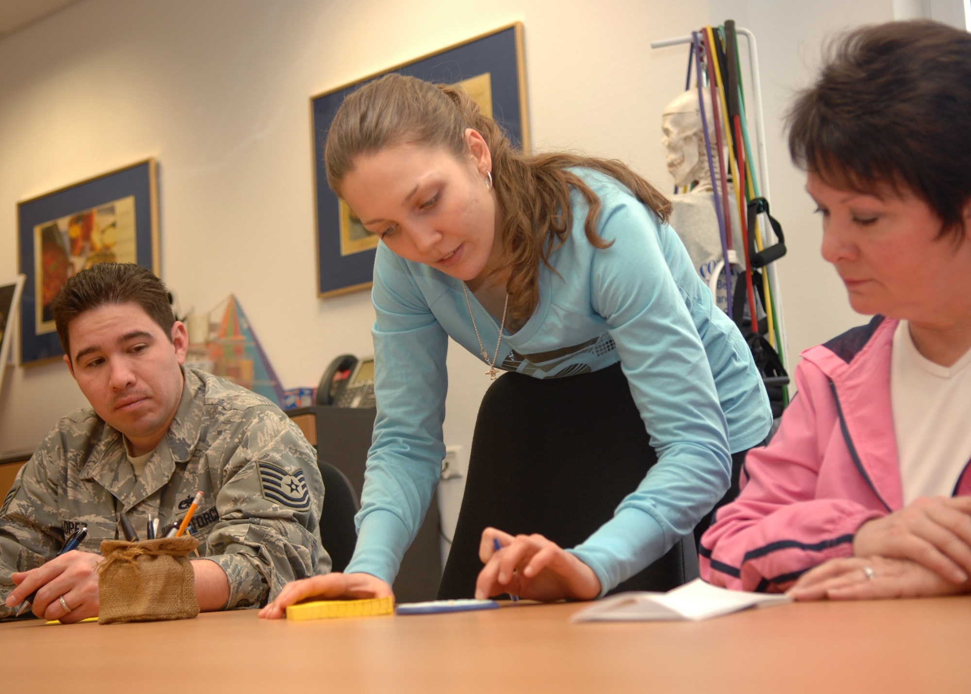 SPANGDAHLEM AIR BASE, Germany -- Jessica Griffith, exercise physiologist and class instructor, explains to Tech. Sgt. Michael Lopez, 52nd Aircraft Maintenance Squadron, and Sandy Ryan, spouse of Louis Ryan, 52nd Operations Support Squadron, how to calculate the appropriate heart rate range crucial to improving cardiovascular fitness as part of the Jump Start class, Feb. 3. The class is an informative one-hour seminar focused on improving nutrition and exercise habits. (U.S. Air Force photo by Airman Staci Miller)