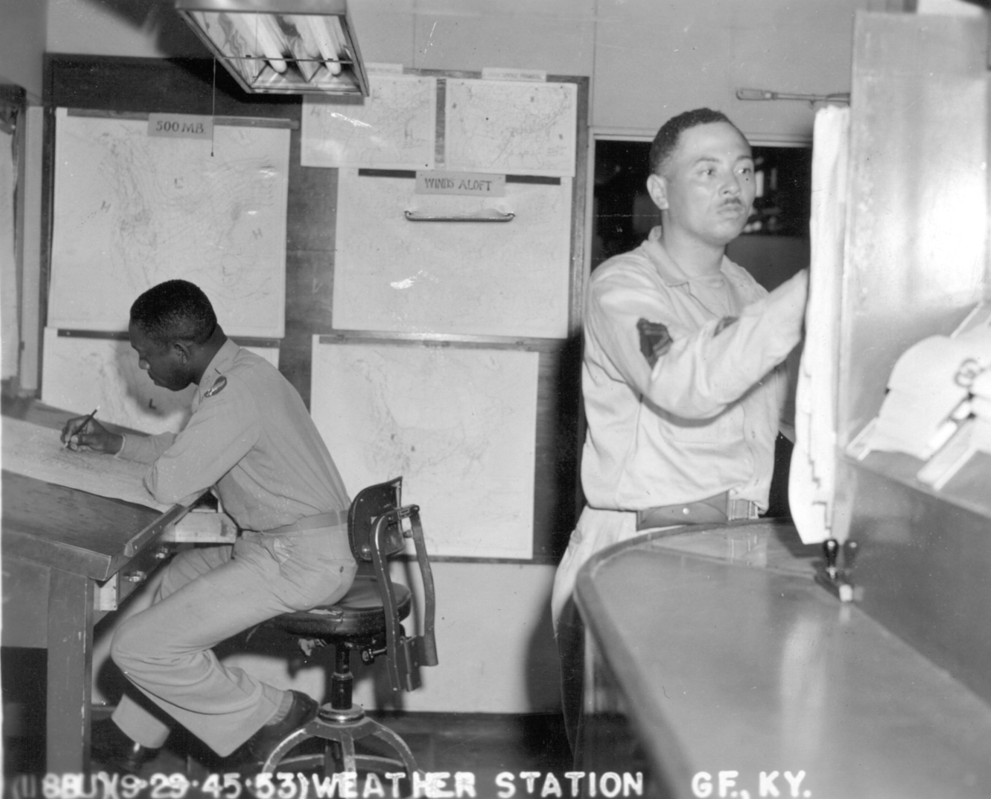 GODMAN FIELD, Ky. -- Two observers prepare a forecast in the weather office in 1945. More than 50 African-American's served as weather forecasters and observers while more than 10 served as meteorological aviation officers during World War II.