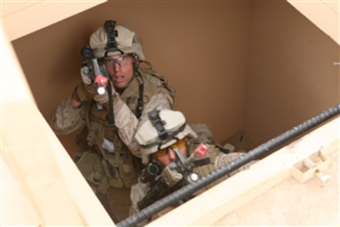 U.S. Marines with 1st Battalion, 8th Marine Regiment clear a roof during a clear, hold and build exercise at Marine Corps Air Ground Combat Center, Twentynine Palms, Calif., on Jan. 20, 2009. The Marines are training for an upcoming deployment.  