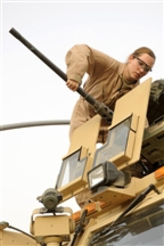 U.S. Air Force Senior Airman Lauren Badger, assigned to Detachment 3, 732nd Expeditionary Security Forces Squadron, removes the barrel of an M-2 .50-caliber machine gun at Forward Operating Base Falcon, Iraq, on Jan. 30, 2009.  