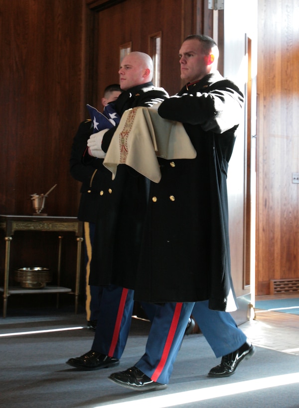 Cpl. Gerald Konieczki and Cpl. Jason Darby, Marine Barracks Washington, escort the remains of a fallen warrior during a funeral service at Arlington National Cemetery in Arlington, Va., Feb. 5. Lance Cpl. Julian T. Brennan was killed in action Jan. 24 as a result of injuries after being struck by an improvised explosive device while conducting combat operations in Farah Province, Afghanistan. Brennan is the first enlisted Marine to receive a full honors funeral under new CMC policy.