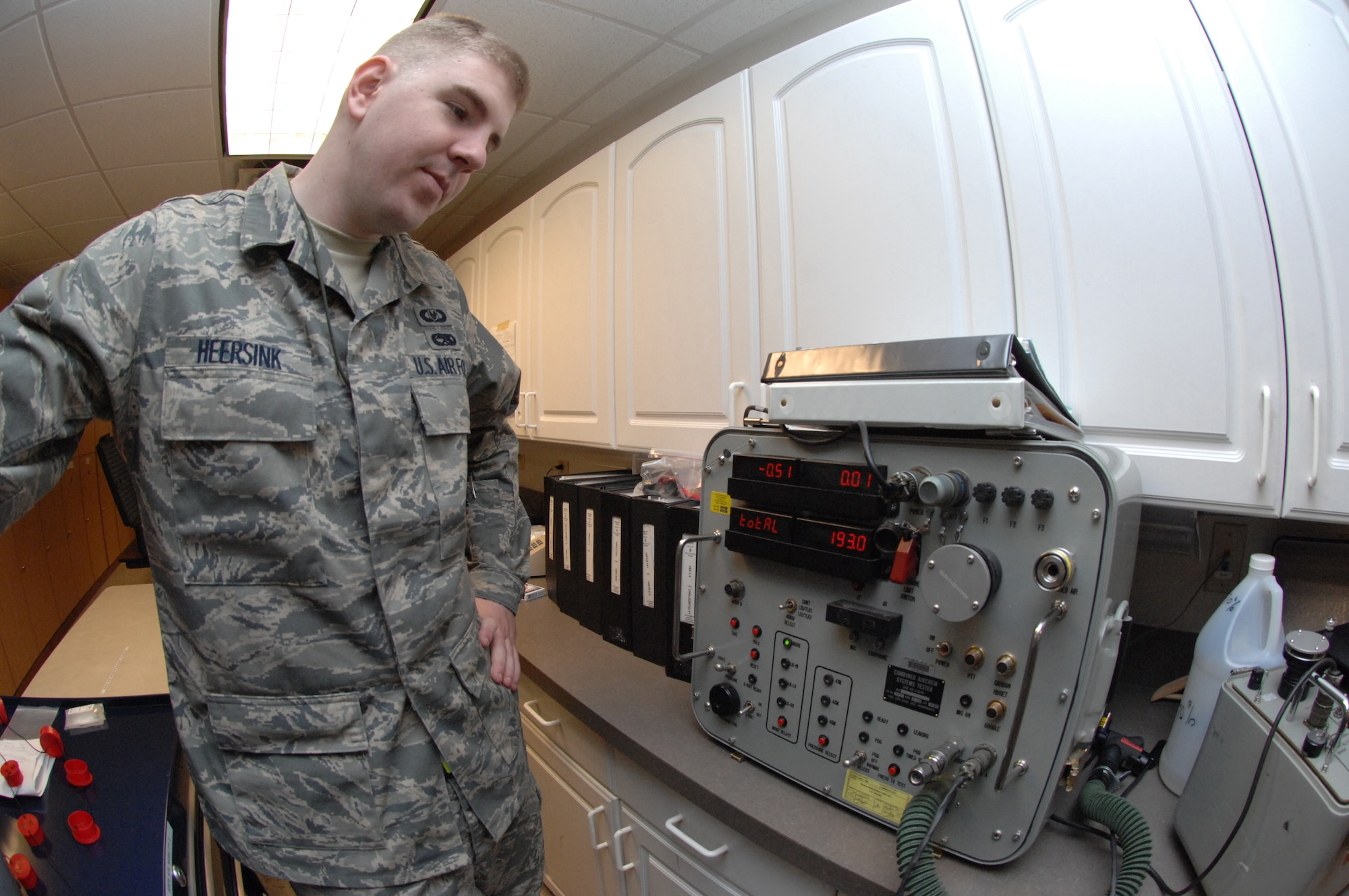 NELLIS AIR FORCE BASE, Nev. -- Senior Airman Shane Heersink, 3rd Operations Support Squadron aircrew flight equipment technician, tests aircrew flight gear with the combined aircrew system tester. Airman Heersink is here supporting the 525th Fighter Squadron participating in RED FLAG 09-2. RED FLAG is a multinational exercise providing a realistic environment to practice combat scenarios. The experience gained during the exercise is vital to the survival of the pilots in combat. (U.S. Air Force photo/2nd Lt. Noelle Caldwell)