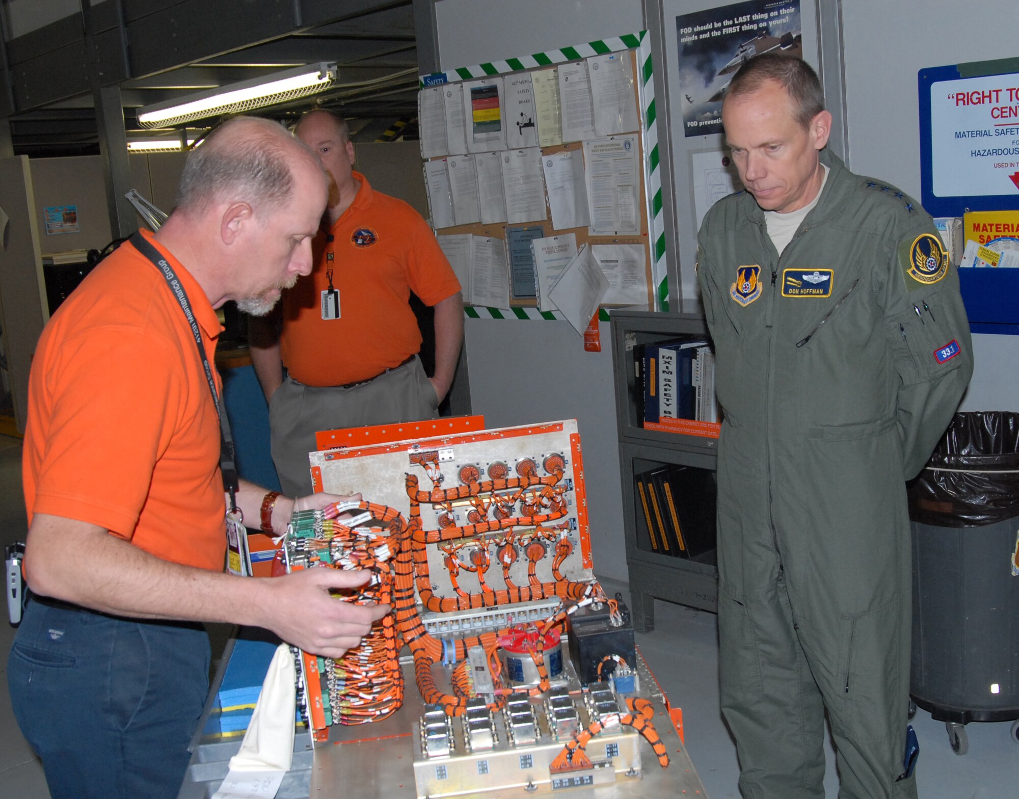 Mike Golackson, 412th Test Engineering Group chief of Instrumentation Operations, shows sample wiring to Gen. Donald Hoffman, commander of Air Force Materiel Command, at hangar 1600 Feb. 4. During General Hoffman's visit, he toured various places around Edwards to better understand the base's mission. (Air Force photo by Airman 1st Class William O'Brien)