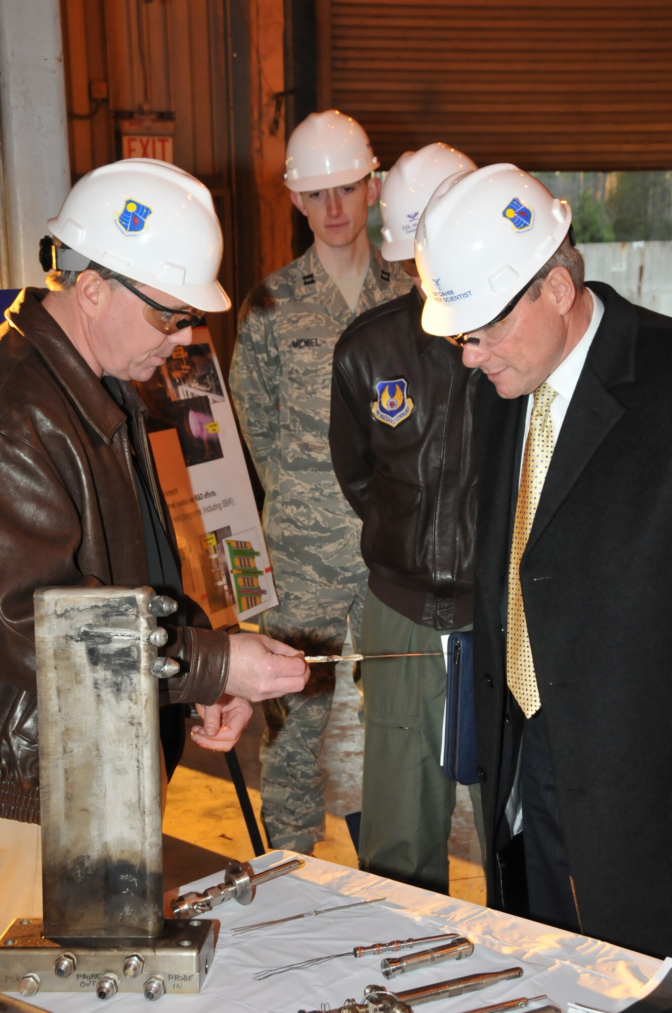 Gregg Beitel, ATA Technology and Analysis branch engineer, shows Air Force Chief Scientist Dr. Werner Dahm some of the instrumentation that has been tested using the J85 engine at the Propulsion Research Facility on the campus of UTSI. Capt. Chuck McNiel and AEDC Commander Col. Art Huber look on. (Photo by David Housch)