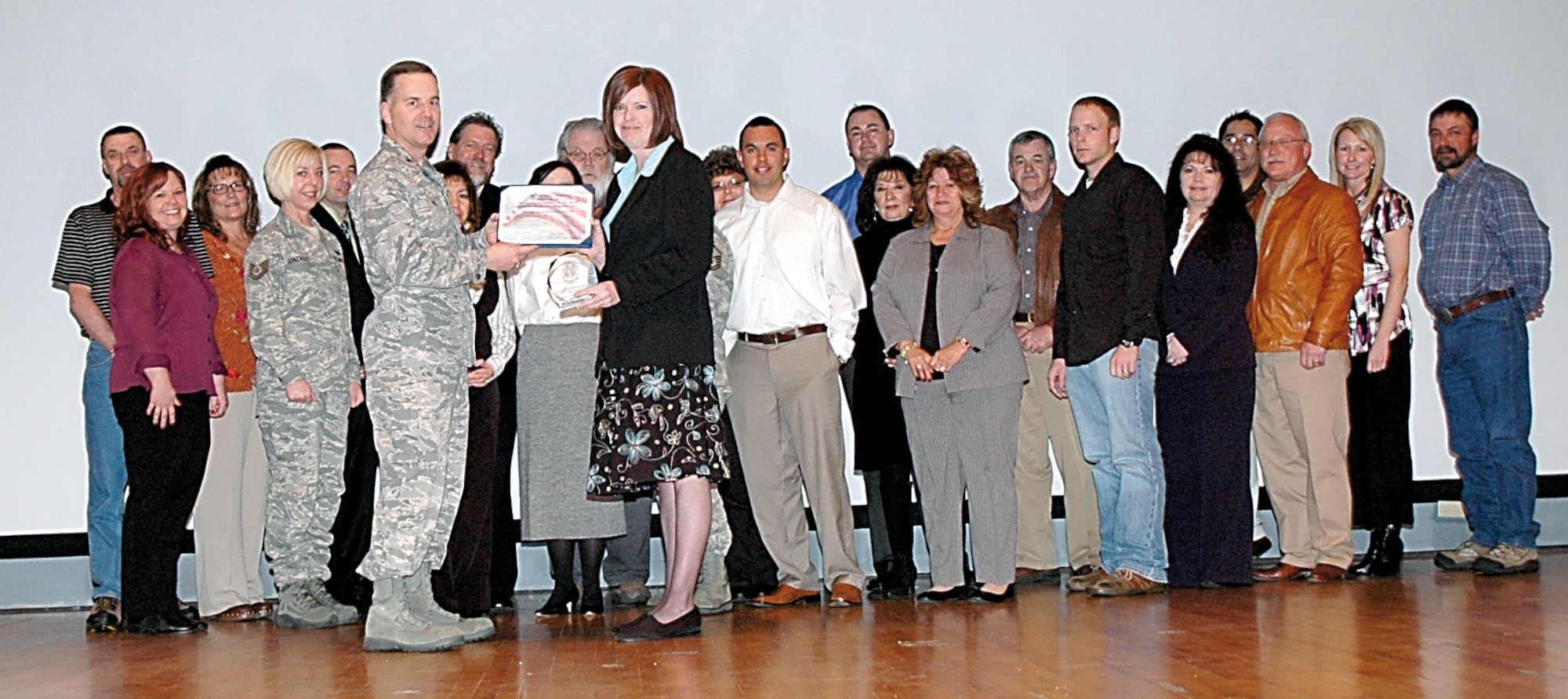 Col. Eric Fox, 748th Supply Chain Management Group commander (left, holding award) presents the Air Force Materiel Command's 2007 Supply Chain management of the Year, Outstanding Supply Chain Management  Team award to the 748th SCMG Shipping and Receiving Wing during a ceremony Jan. 29. Others received awards as well. 