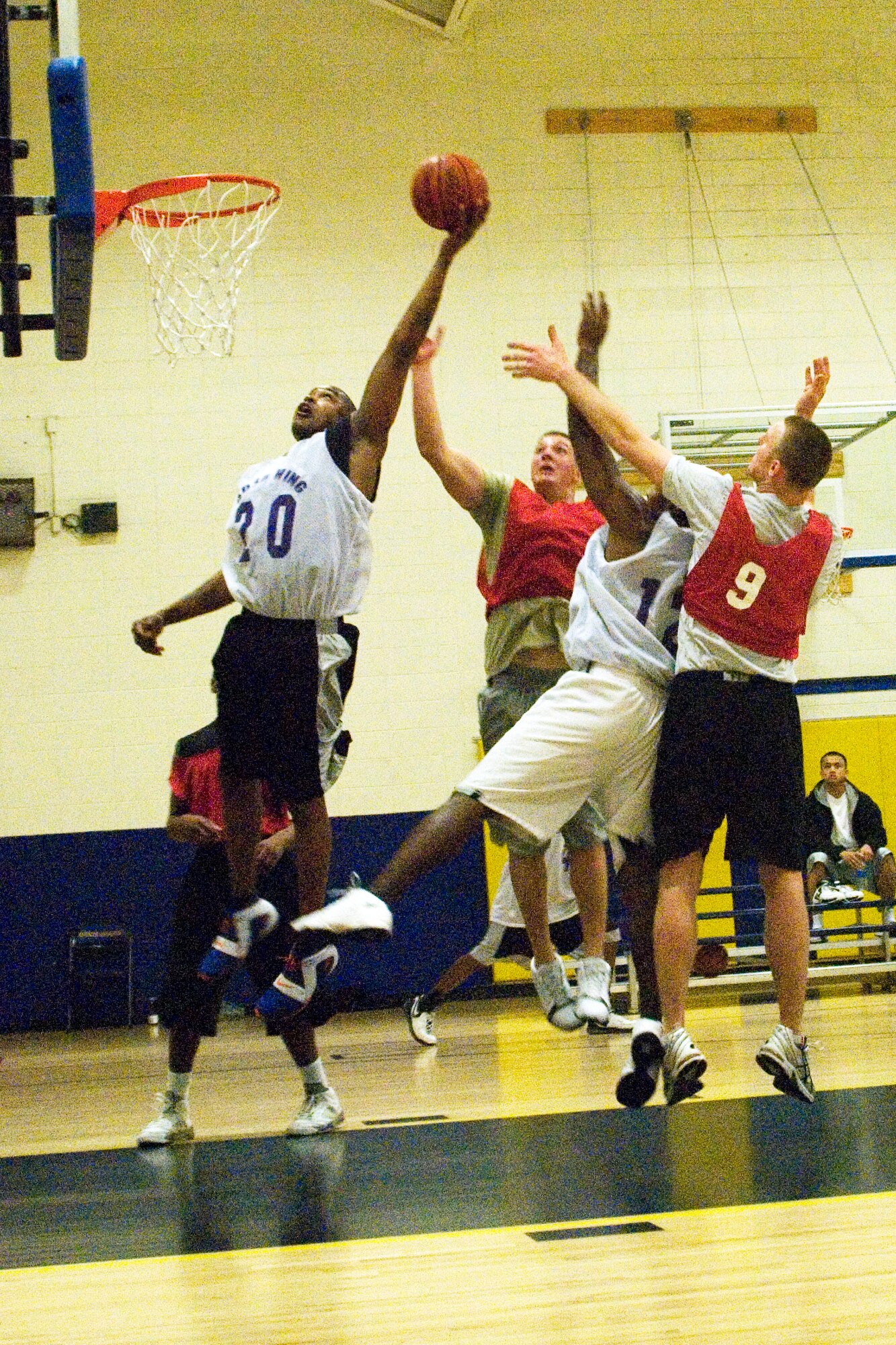Senior Airman Nathan McQuirter, 403rd Maintenance Squadron, dunks the ball amidst a fierce defense, adding to his 14-point tally in the first game of the double-elimination Western Division playoff game.  Reservists from the 403rd Wing?s intramural basketball team eked out the narrow 39-36 victory in the first game against the 335th Training Squadron held at the Blake fitness center Feb. 4.  They lost the second game 34-77 against the 81st Medical Group.  The team managed to finish the season second place in the division, despite missing half of their starting line-up in the playoffs due to a deployment.  (U.S. Air Force photo by Staff Sgt. Tanya Holditch