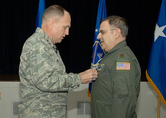 Maj. Gen. Ralph Jodice, Air Force District of Washington Commander, pins the Joint Service Commendation Medal onto the uniform of Maj. Mitchell E. Fadem during the quarterly AFDW Commander's Call held at the Andrews Air Force Base, Md., Community Center Feb. 6. Major Fadem earned the medal for his service while deployed in support of Operation Enduring Freedom from April to July 2007.