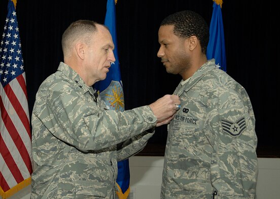 Maj. Gen. Ralph Jodice, Air Force District of Washington Commander, pins the Air Force Commendation Medal onto the uniform of Staff Sgt. Jeremy F. Gilchrist during the AFDW Commander's Call held at the Andrews Air Force Base, Md., Community Center Feb. 6. Sergeant Gilchrist earned the medal for his service while assigned to the 844th Communications Group, AFDW, from December 2005 to August 2008.