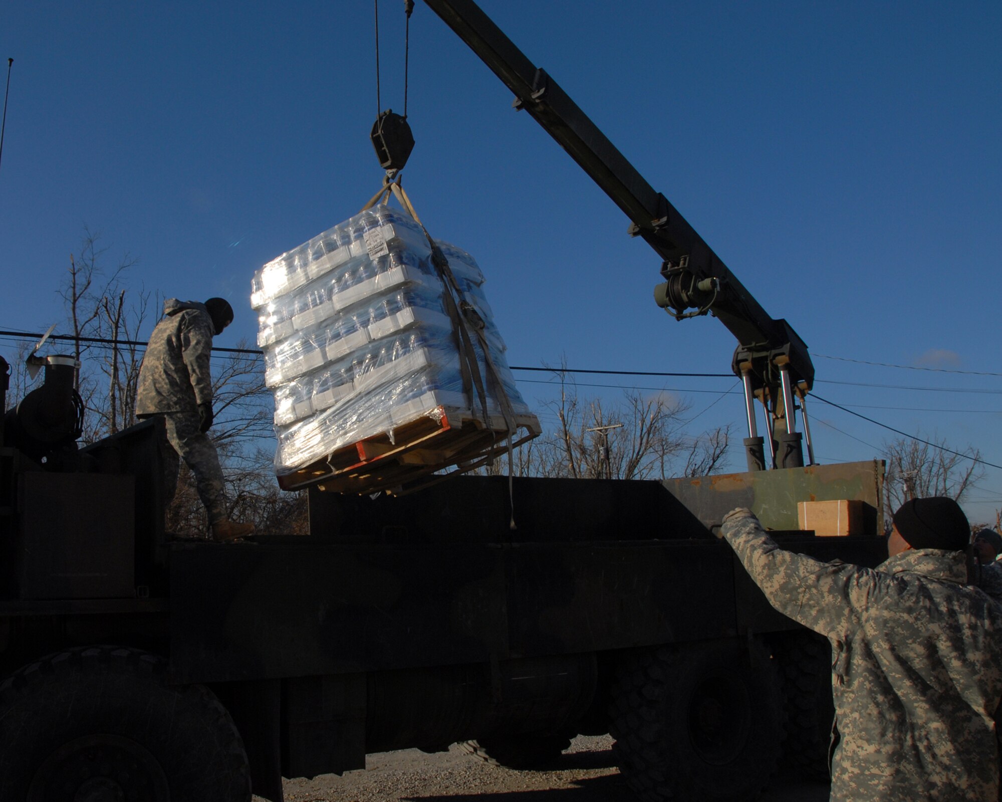 Kentucky Army National Guard member, Sgt. 1st Class, Robbie Rogers, Bravo Battery, from Campbelsville, Kentucky.  Operates a crane to deliver cases of bottled water to the disaster stricken community of Wickliffe, Kentucky.
