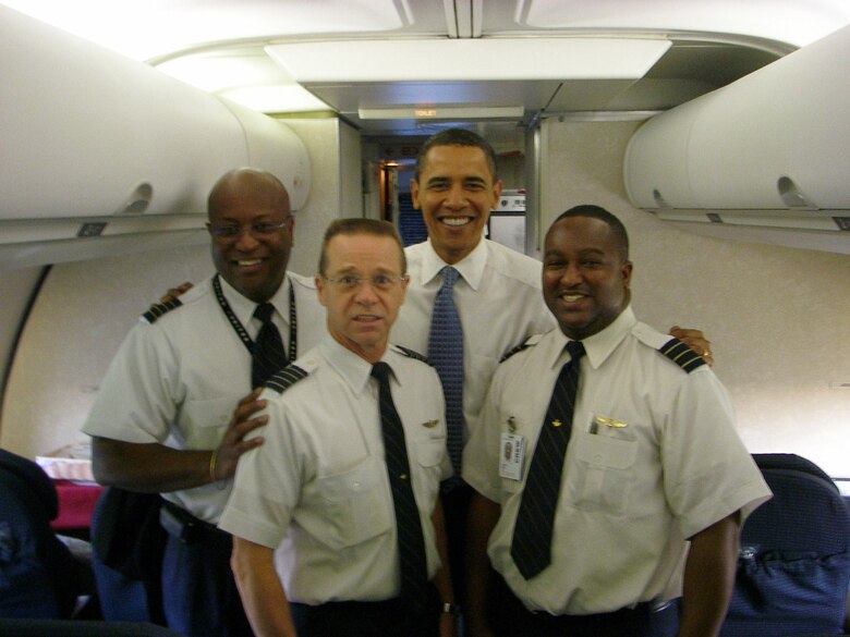 From left, Maj. Irby Rivera, Col. Pete Maynard, President-elect Barack Obama and Maj. Jon Bryant pose for the camera on Mr. Obama's last commercial charter flight before becoming president of the United States. All three military officers are Citizen Airmen and commercial airline pilots in civilian life. (Courtesy photo)

