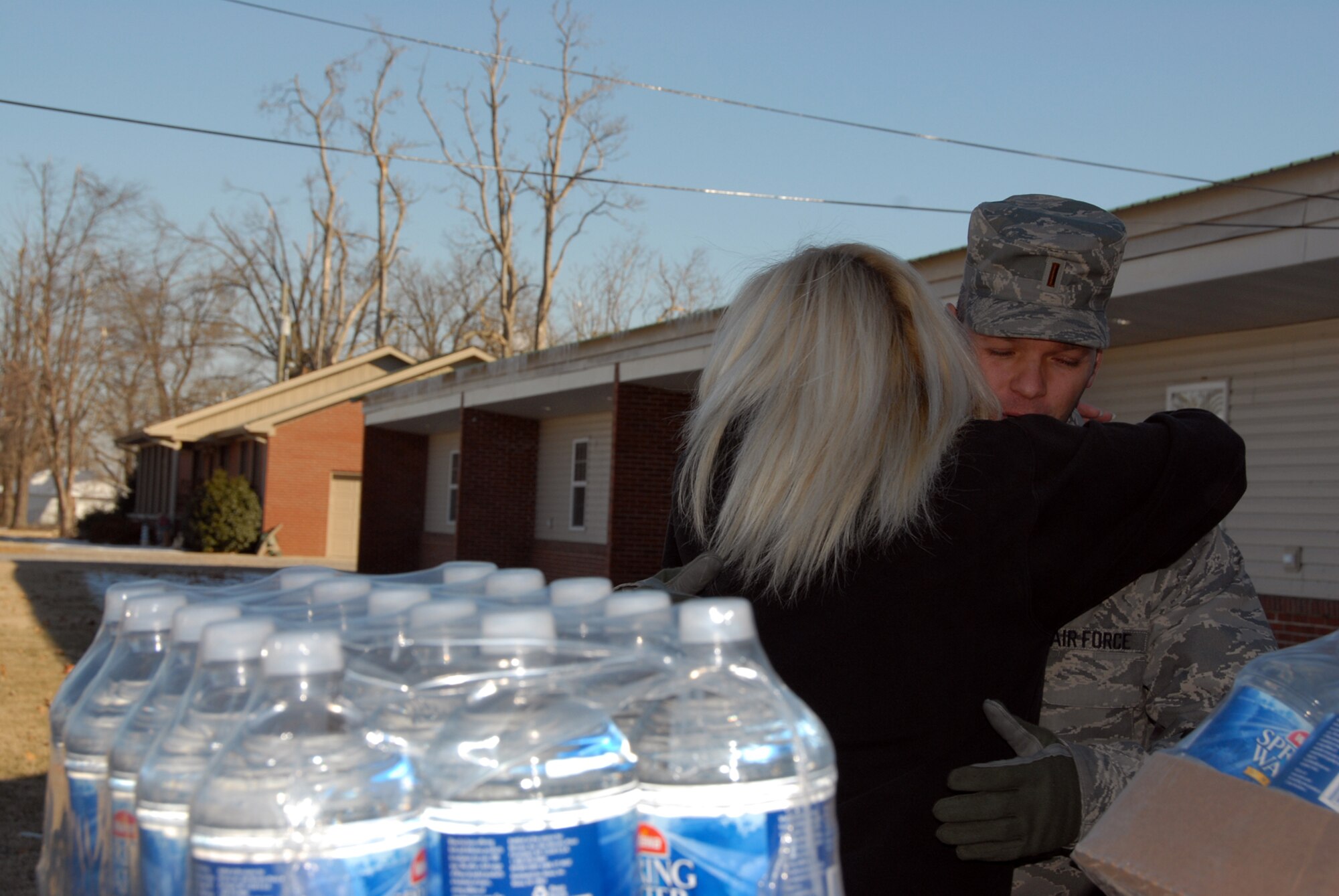 Kentucky Air National Guard member, 2nd Lt. James Campbell, 123rd Maintenance Squadron.  Receives a grateful hug from a resident in Banadana, Kentucky during ice storm relief efforts.
