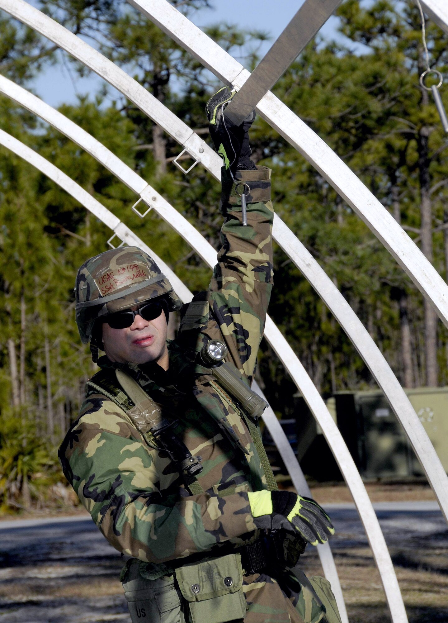Staff Sgt. Neftali Rivera erects a tent during a Silver Flag exercise Feb. 5. Silver Flag exercise is a training exercise conducted at Tyndall Air Force Base, Fla., to train military personnel within their prespective career field. Sergeant Rivera is a firefighter from the 104th Fighter Wing Massachusetts Air National Guard. (U.S. Air Force photo/Master Sgt. Mark Fortin)