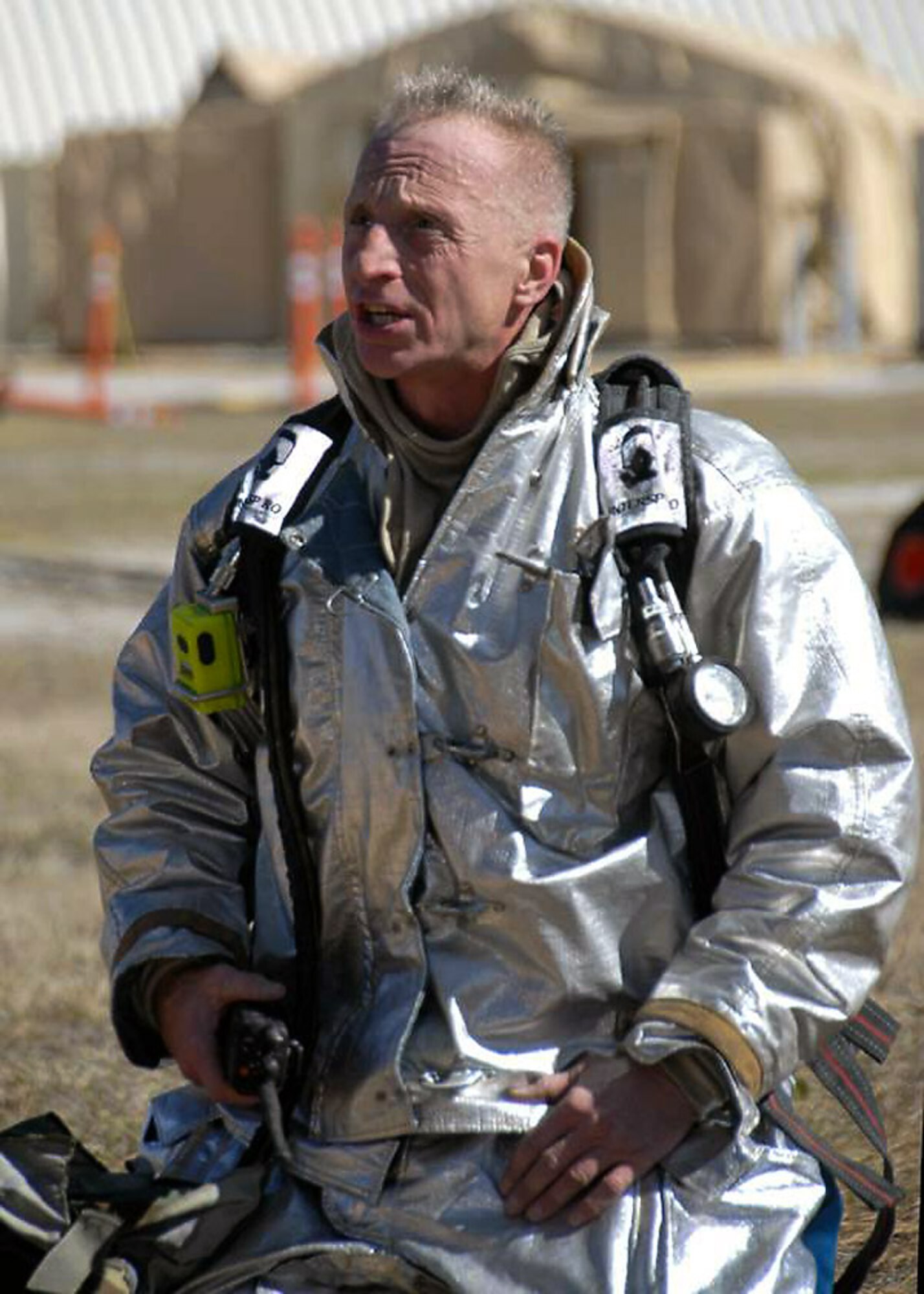Master Sergeant Thomas J. Miskiv from the 104th Fighter Wing, Massachusetts Air National Guard catches his breath after fighting a simulated house fire during the Civil Engineering Silver Flag exercise held on February 5, 2009. The Civil Engineering Squadron Silver Flag exercise is an annual training exercise conducted at Tyndall Air Force Base Florida to train military personnel within their career fields. (Photograph by Senior Master Sgt. Robert J. Sabonis, USAF) 
