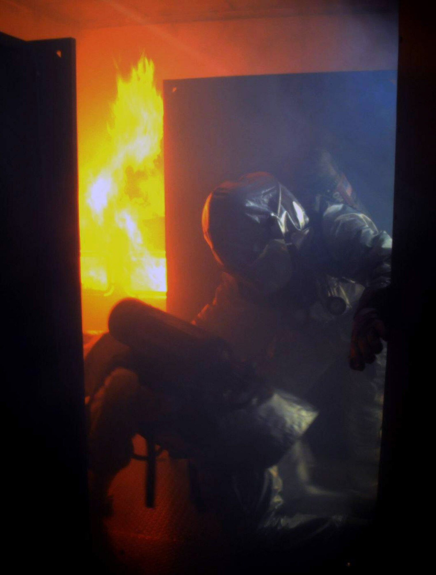 Firefighters work to extinguish a fire during a Silver Flag exercise Feb. 5. Silver Flag is training for Air Force members to learn new skills in a simulated combat environment at Tyndall Air Force Base, Fla. (U.S. Air Force photo/Senior Master Sgt. Robert J. Sabonis)