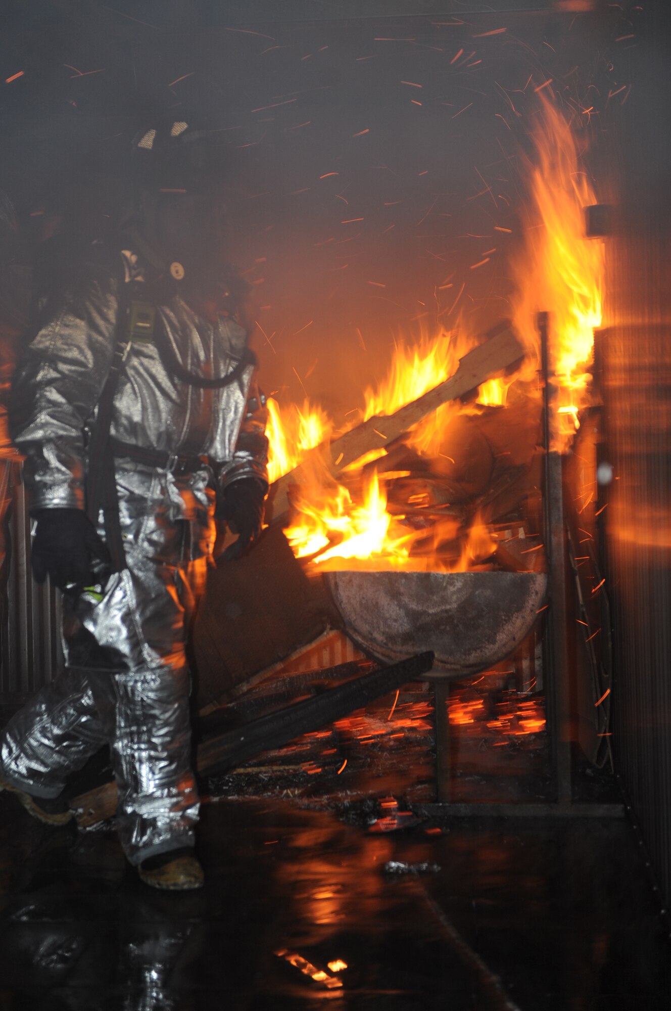 Airman 1st Class Daniel Lovely, 28th Civil Engineer Squadron fire protection specialist, prepares the structural burn training facility here, Feb. 5. The 28 CES fire department conducts various training scenarios to maintain their readiness qualifications. (U.S. Air Force photo/Airman 1st Class Joshua J. Seybert)