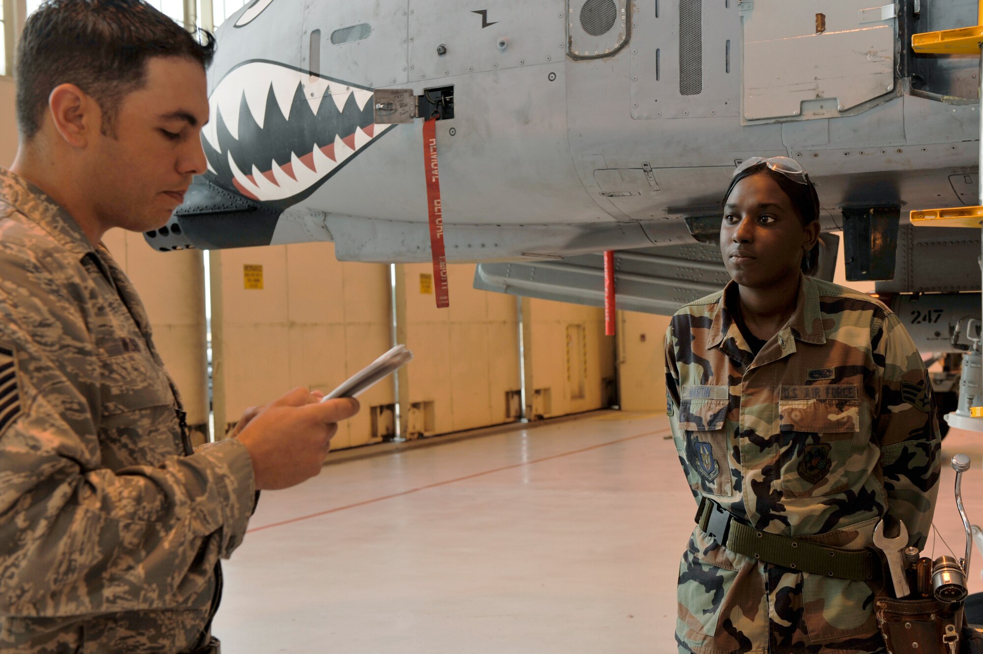 MOODY AIR FORCE BASE, Ga. -- Master Sgt. Jonathon Wilson, weapons flight chief, 442nd fighter Wing Det. 1, reads instructions and warnings to Senior Airman Dunnuia Martin, 442nd weapons crew member, prior to loading a GBU-38 bomb onto an  A-10 Thunderbolt II Dec. 10, 2008 here. (U.S. photo by Senior Airman Schelli Jones)