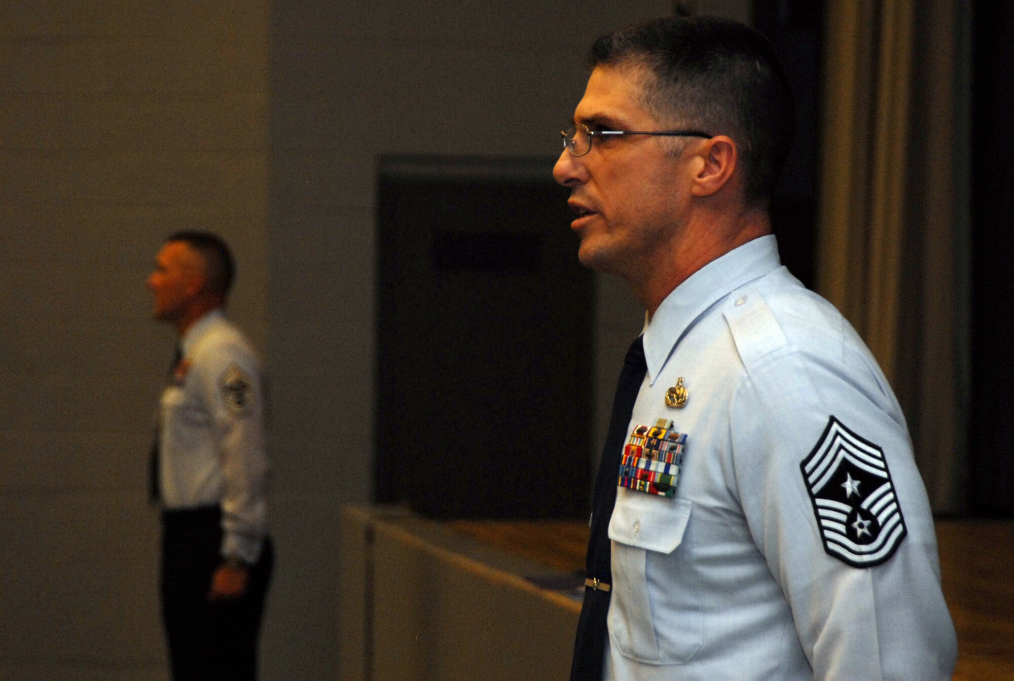Chief Master Sgts. Eric Jaren (foreground), 95th Air Base Wing command chief, and Mark Brejcha, 412th Test Wing command chief, lead enlisted Airmen and Marines in reciting the Airman's Creed during a basewide enlisted call at the base theater Feb. 2. Other topics included Edwards Blue Eagles Honor Guard opportunities, the sexual assault program, medical and dental appointment processes, Airman's Council and volunteer opportunities. (Air Force photo by Senior Airman Julius Delos Reyes)