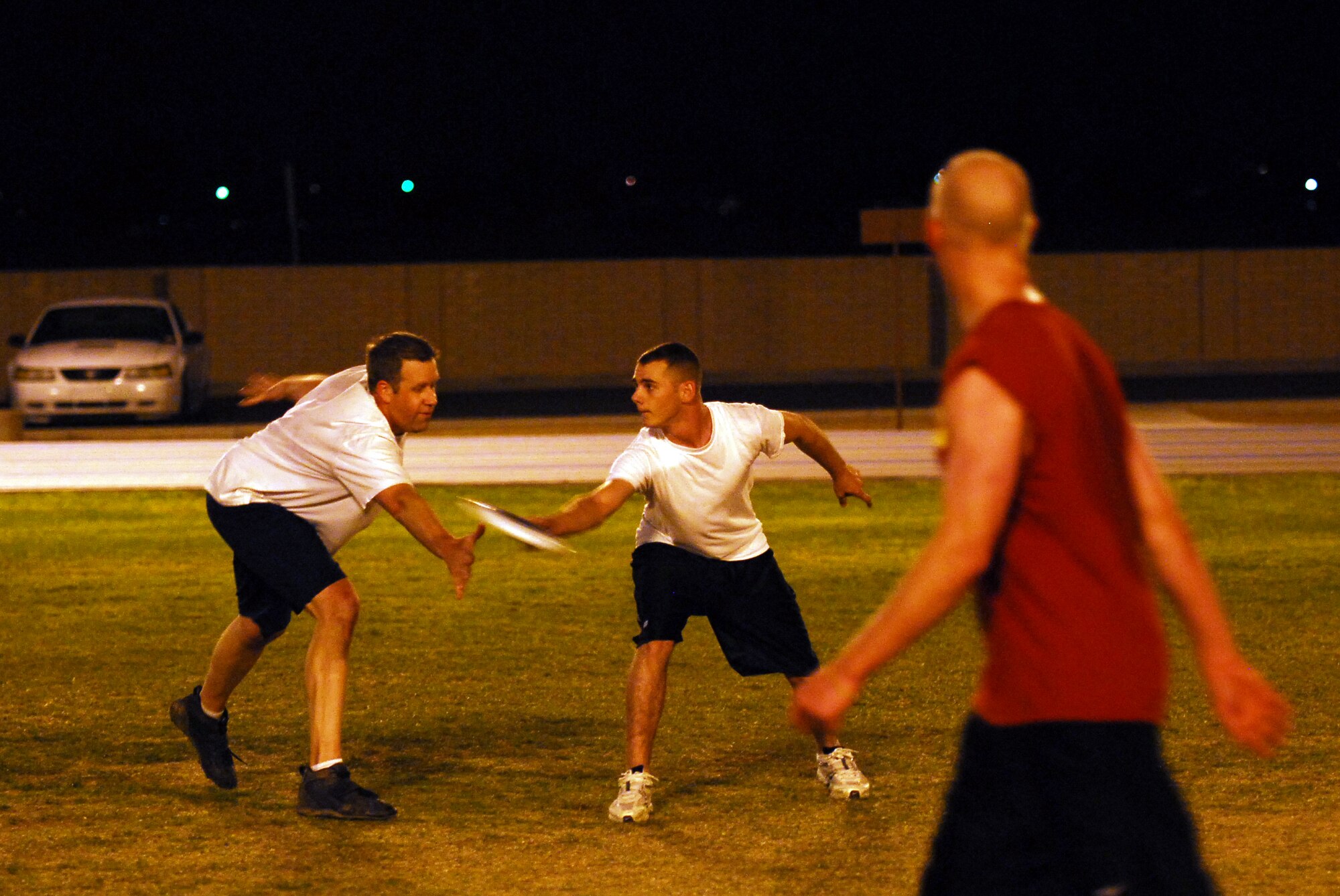 Master Sgt. Brent Matthews, 56th Communications Squadron trys to block Chek Glenn, 56th Component Maintenance Squadron, from passing the Frisbee to a team member during the Luke Air Force Base Ultimate Frisbee championship Feb. 4. "It was a tough fought game, CS played very well and we were caught off guard by how fast they came out the gates but we recouped as a team and played our best Frisbee in our second match," said Guillermo Uriarte, CMS team captain.