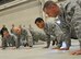 For being late to the 33rd Fighter Wing’s propulsion shop, Command Chief Master Sgt. Steve Sullens, Air Combat Command, does pushups with other Airmen handpicked by a squadron member Feb. 5 during the chief’s tour of the wing. (U.S. Air Force Photo/Chrissy Cuttita)