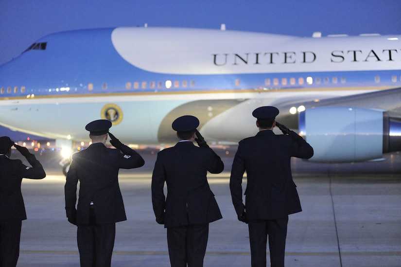 Col. Steven Shepro, 316th Wing commander, and 316th Wing protocol members render a salute as Air Force One departs on Feb. 5. President Obama traveled to Williamsburg, Va. to speak, urging House Democrats tonight to set aside their differences with the Senate and Republicans in order to push forward quickly with the stimulus package. (US Air Force/Bobby Jones)