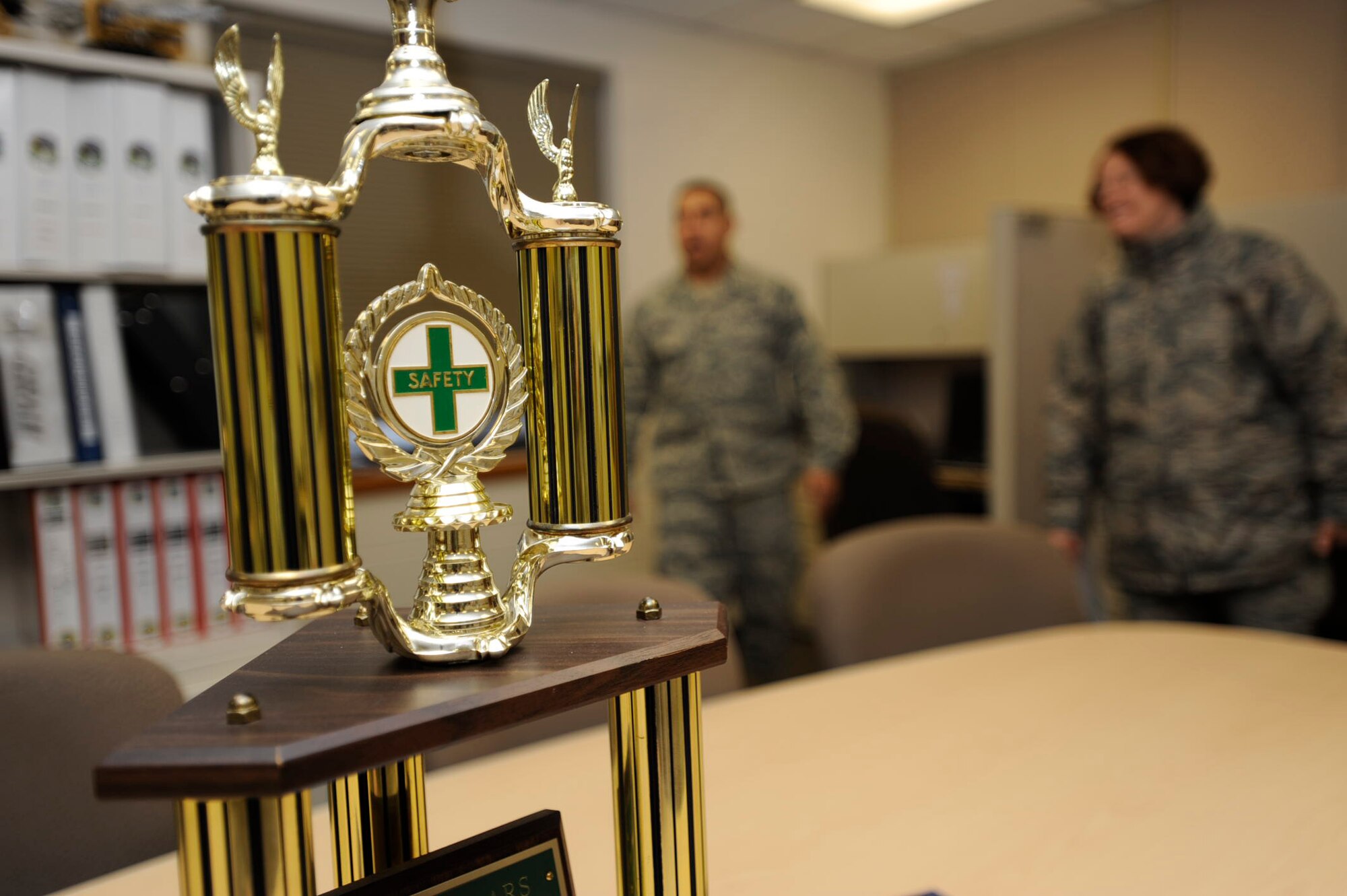 The trophy given annually to the 931st Air Refueling Group unit with the best safety program sits proudly in the headquarters of the 931st Civil Engineer Squadron. In the background, Tech. Sgt. Howard Burns helps Staff Sgt. Regina Rector look for safety concerns in the room. Sergeant Burns is the CES facilities manager and Sergeant Rector is the superintendent of safety for the 931st Air Refueling Group, an Air Force Reserve unit at McConnell Air Force Base, Kan. A team of safety inspectors is scheduled to start evaluating the 931st ARG Friday. (U.S. Air Force photo/Tech. Sgt. Jason Schaap)