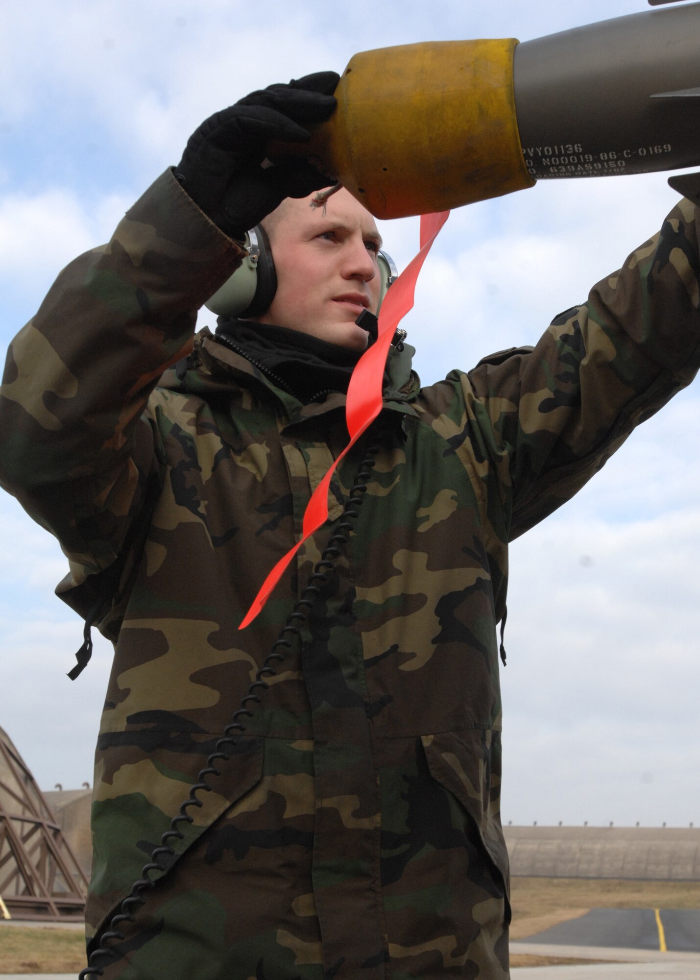 SPANGDAHLEM AIR BASE, Germany -- Senior Airman Ryan Daschofsky, 52nd Air Maintenance Squadron, removes an Aim-9 cover on an A-10 Warthog Jan. 28, 2009.  A routine pre-flight inspection is completed prior to the launch of the aircraft. (U.S. Air Force photo by Senior Airman Jenifer H. Calhoun)