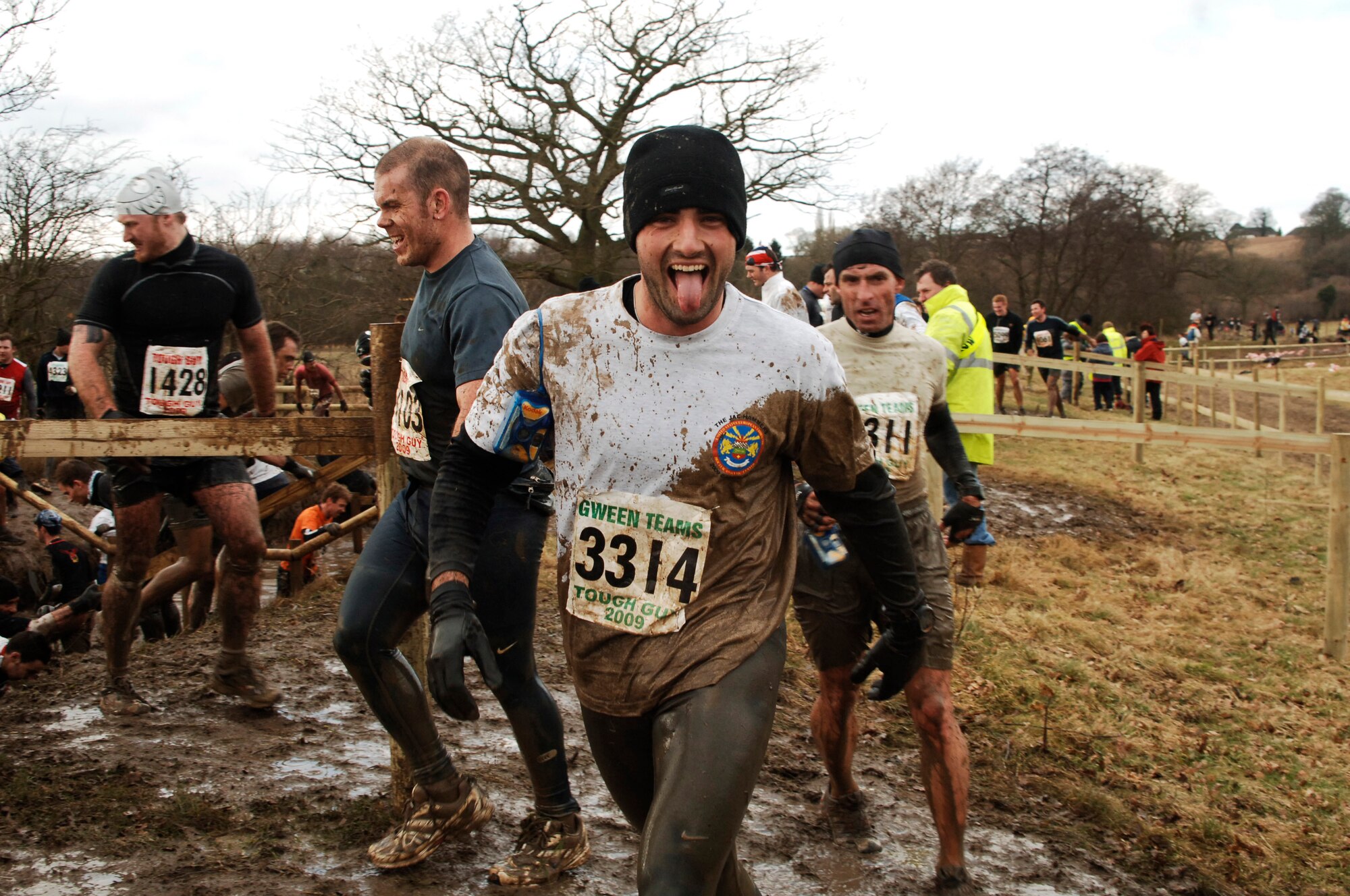 Navy Lieutenants Adam Waltz (foreground) and Daniel Avondoglio (to his left) during the February 1, 2009 Tough Guy Challenge in Perton, England.  The two officers were part of the JAC HAMMERS team - all of which completed the cold, wet, and muddy obstacle strewn course.  (U.S. Air Force photo by Staff Sgt. Rachel Goff)