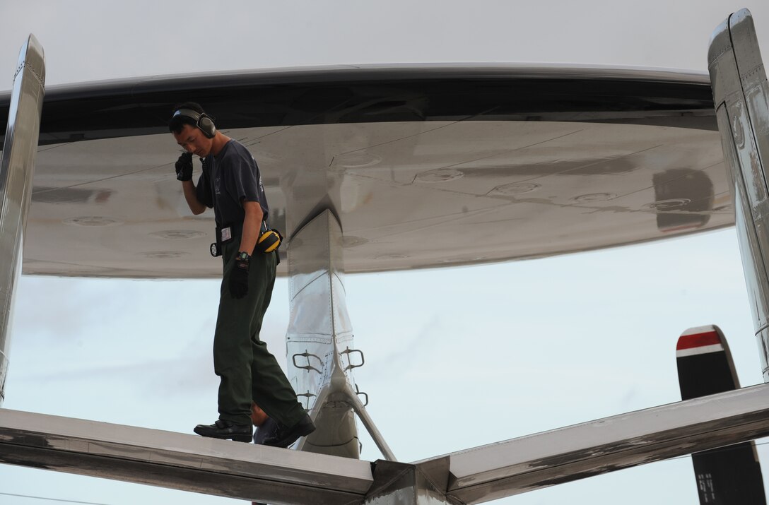 Sgt. Masatsugo Yamaguchi, aircraft maintainer, Japan Air Self Defense Force inspects an E2-C aircraft Feb. 5 at Andersen Air Force Base, Guam during Cope North 09-1 after a local area mission. Units from the U.S. Air Force, U.S. Navy and the Japan Air Self Defense Force will participate in exercise Cope North 09-1 at Andersen from 2-13 Feb. The exercise is the first iteration of a regularly scheduled joint and bilateral exercise and is part of the on-going series of exercises designed to enhance air operations in defense of Japan. (U.S. Air Force photo/ Master Sgt. Kevin J. Gruenwald) released      