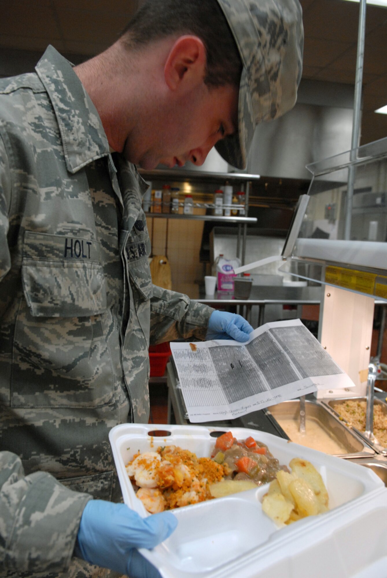 Staff Sgt. Justyn Holt, 8th Force Support Squadron, prepares individual meals for the 8th Maintenance Group and 8th Security Forces Squadron Airmen at Kunsan Air Base, Republic of Korea, Feb. 6, 2009. The O' Malley Dining facility staff make more than 500 "to go meals" every  day.(US Air Force Photo By Senior Airman Angela Ruiz)