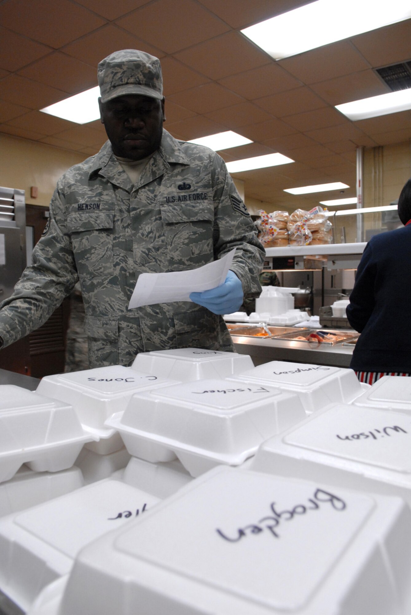 Staff Sgt. Kenneth Henson, 8th Force Support Squadron, prepares individual meals for the 8th Maintenance Group and 8th Security Forces Squadron Airmen at Kunsan Air Base, Republic of Korea, Feb. 6, 2009. The O' Malley Dining facility staff make more than 500 "to go meals" every  day.(US Air Force Photo By Senior Airman Angela Ruiz)
