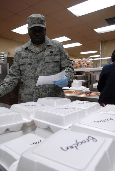 Staff Sgt. Kenneth Henson, 8th Force Support Squadron, prepares individual meals for the 8th Maintenance Group and 8th Security Forces Squadron Airmen at Kunsan Air Base, Republic of Korea, Feb. 6, 2009. The O' Malley Dining facility staff make more than 500 "to go meals" every  day.(US Air Force Photo By Senior Airman Angela Ruiz)