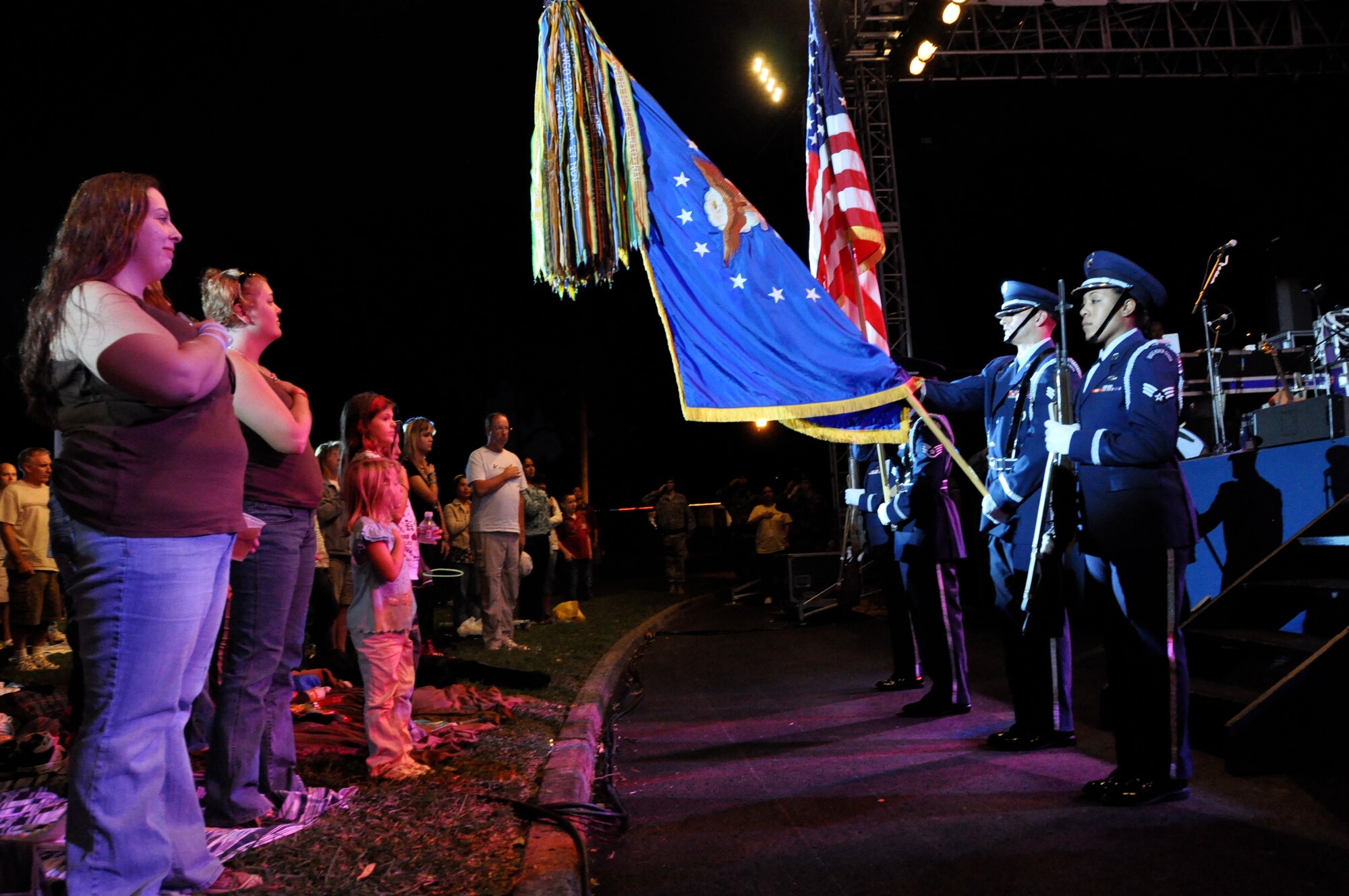 HICKAM AFB - Hickam Air Force Base, Hawaii personnel stand to the National Anthem prior to listening to CSI television show star and Blue Island, Ill. native Gary Sinise and his band, "Lt. Dan Ban" perform on Jan. 31, 2009. Sinise and his "Lt. Dan Band" performed at Marine Corps Base Hawaii (MCBH) Kaneohe Bay on Jan 30, 2009 in addition to speaking to Hickam's Airmen and giving them a pep talk for their upcoming Operational Readiness Inspection (ORI). (U.S.  Air Force photo/Tech Sgt. Cohen A. Young) 