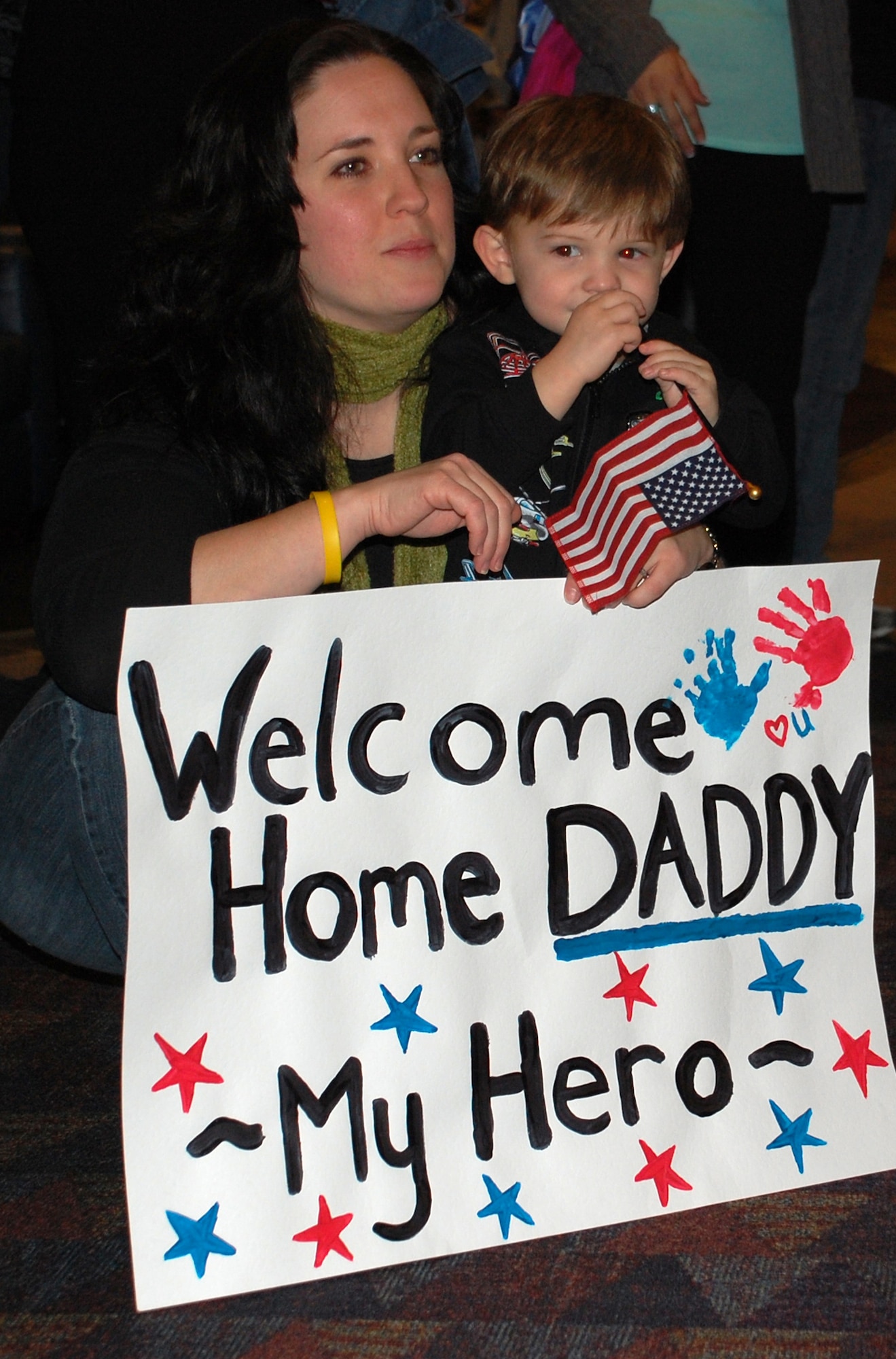 Laurie Sanchez and son Thomas, 2, anxiously await the return of their husband and father, Tech. Sgt. Jody Sanchez, Feb. 5, 2009, at the Colorado Springs Airport in Colorado. Sergeant Sanchez was one of more than 35 Air Force Reserve security forces Airmen deployed from the 302nd Security Forces Squadron at Peterson Air Force Base, Colo., who returned home from a six-month deployment at Kirkuk Regional Air Base, Iraq, in support of Operation Iraqi Freedom. "I can't wait to see him in front of me with Thomas," Mrs. Sanchez said before his arrival. "I'm ready to get back to normal, daily life." (U.S. Air Force photo/Tech. Sgt. Daniel Butterfield)