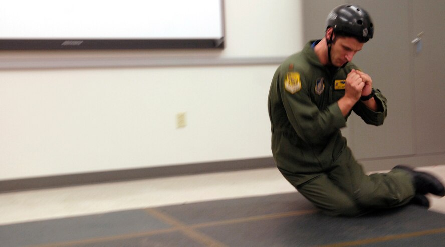 HICKAM AFB - Los Gatos, Calif. native Maj Will Martin, a pilot with the 535th Airlift Squadron, 15th Airlift Wing practices parachute rolling during refresher parachute training on Jan 24, 2009 at Hickam Air Force Base, Hawaii as one of the four classes that they  teach. (U.S.  Air Force photo/Tech Sgt. Cohen A. Young) 