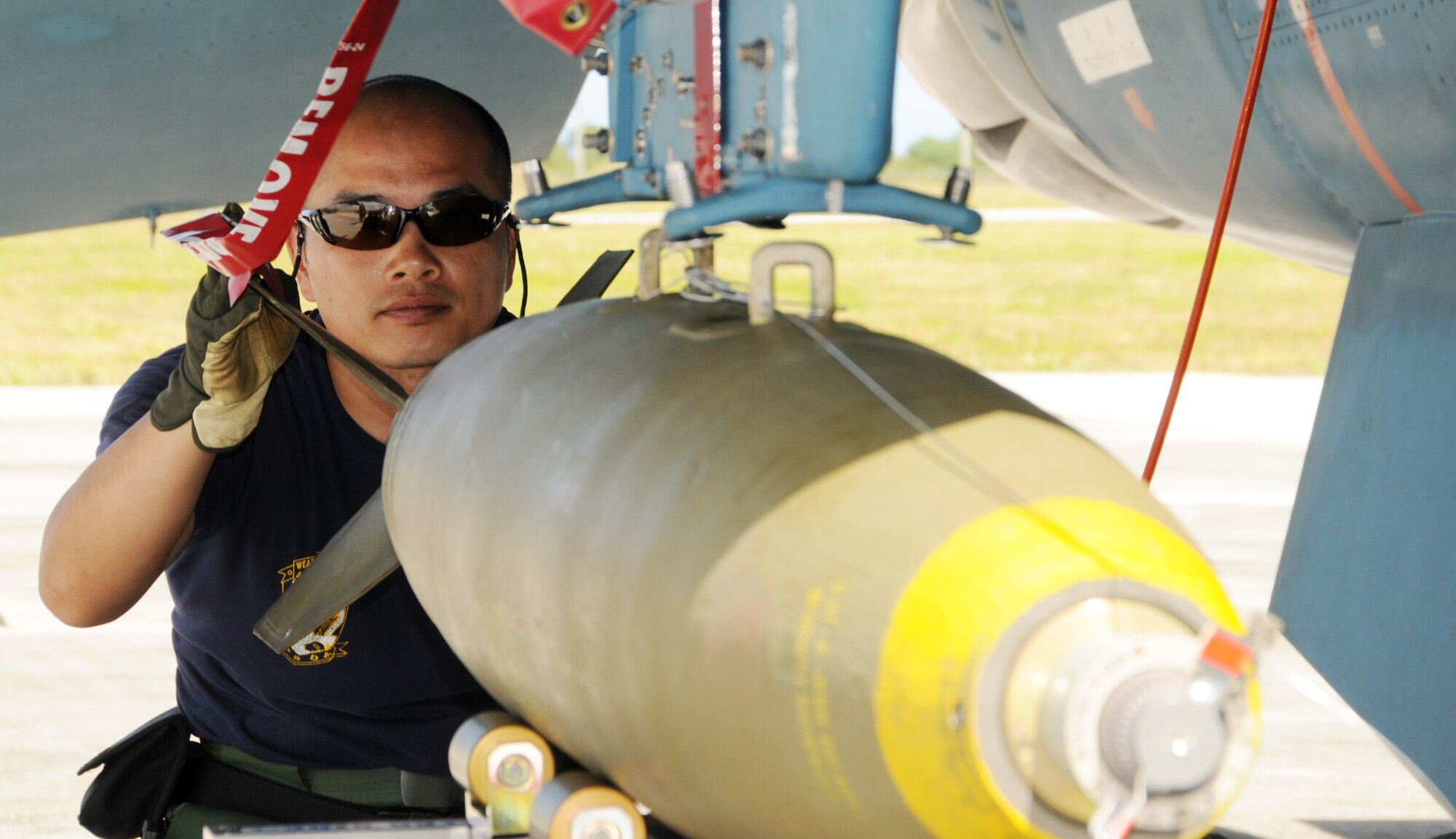 ANDERSEN AIR FORCE BASE, Guam - A Japan Air Self Defense Force Ammunition Squadron armament specialist loads an M-117 on a JASDF F-2 during Cope North here Feb. 5. (U.S. Air Force photo by Senior Airman Nichelle Griffiths)