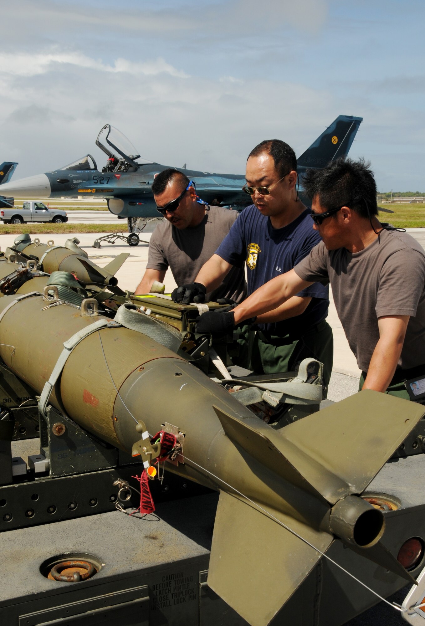 ANDERSEN AIR FORCE BASE, Guam - Japan Air Self Defense Force Ammunition Squadron armament specialists transport M-117 ordnance to a JASDF F2 fighter during Cope North here Feb. 5. Cope North is a bilateral exercise designed to enhance U.S. and Japanese air operations in defense of Japan. (U.S. Air Force photo by Senior Airman Nichelle Griffiths)