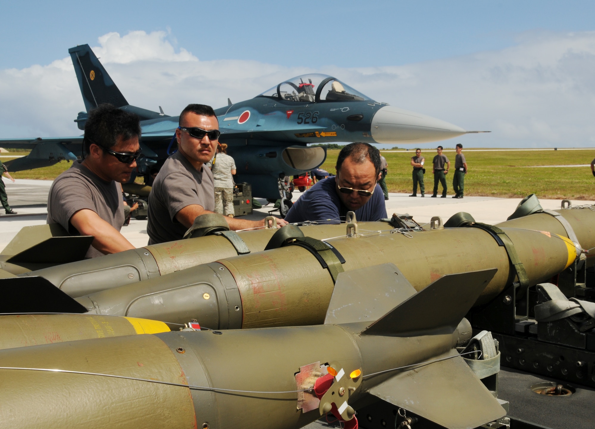 ANDERSEN AIR FORCE BASE, Guam - Japan Air Self Defense Force Ammunition Squadron armament specialists transport M-117 ordnance to a JASDF F2 fighter during Cope North here Feb. 5. Cope North is a bilateral exercise designed to enhance U.S. and Japanese air operations in defense of Japan. (U.S. Air Force photo by Senior Airman Nichelle Griffiths)