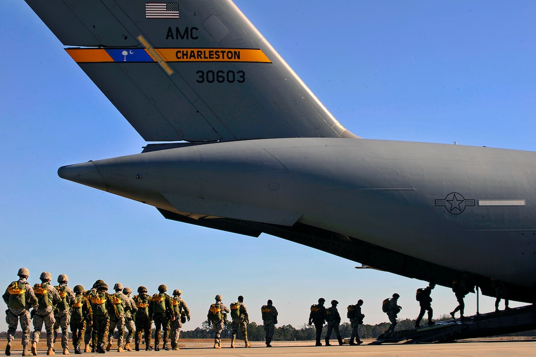 U.S. Air Force airmen assigned to the 820th Security Forces Group and British airmen from a Royal Air Force squadron board a C-17 Globemaster III aircraft to perform a static-line parachute jump over Moody Air Force Base, Ga., Feb. 5, 2009.