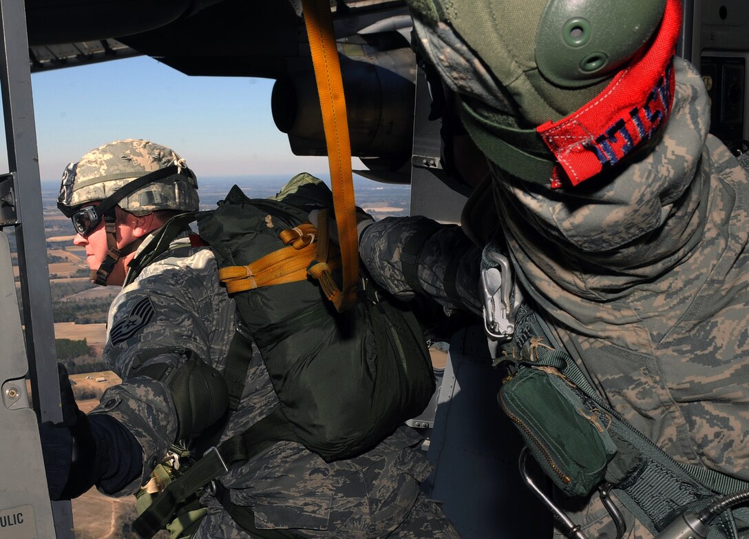 A U.S. airman prepares to perform a static line parachute jump out of a C-17 Globemaster III aircraft over Moody Air Force Base, Ga., Feb. 5, 2009. The airmen are assigned to the 820th Security Forces Group and personnel from a Royal Air Force regiment also perform a static-line parachute jump.