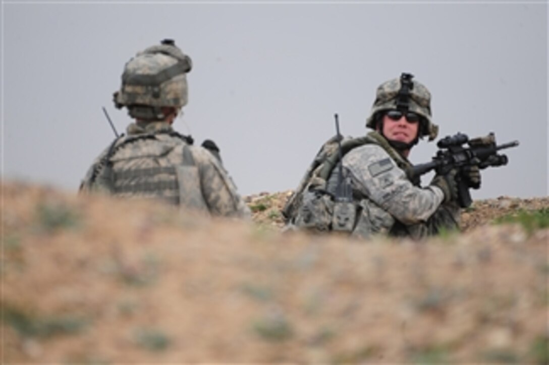 U.S. Army Sgt. Martin Pruner (right) and Spc. John Gangluff (left) assigned to Charlie Company, 2nd Infantry Battalion, 35th Infantry Regiment, 3rd Brigade Combat Team, 25th Infantry Division provide outer security during the elections in Samarra, Iraq, on Jan. 31, 2009.  