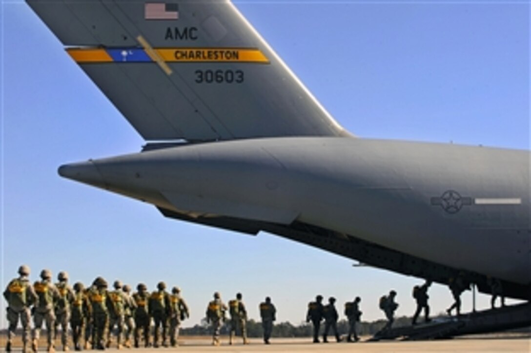 U.S. Air Force airmen and personnel from a Royal Air Force regiment board a C-17 Globemaster III to perform a static-line parachute jump over Moody Air Force Base, Ga., Feb. 5, 2009. The airmen are assigned to the 820th Security Forces Group. The RAF is visiting to participate in Operation Winged Eagle, a joint training exercise.