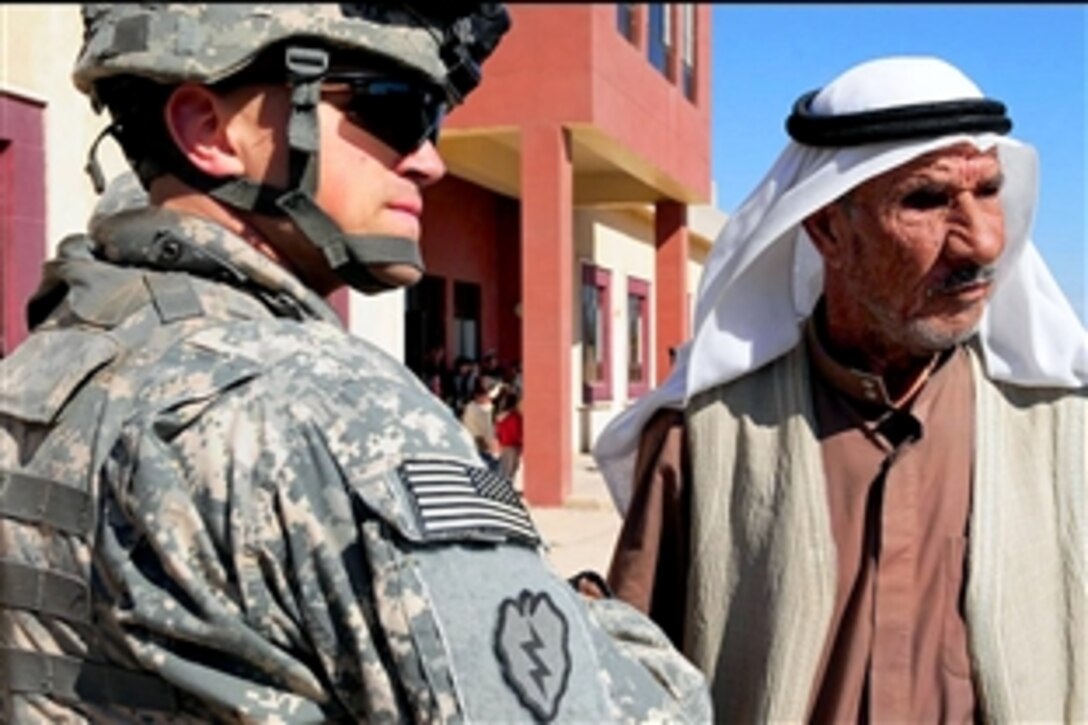 U.S. Army Capt. Ben Boeskestien talks with a sheik from Samarra, Iraq, while Coalition forces provided supply and aid services to the Samarra Clinic, Feb. 3, 2009. Boeskestien is commander for the 25th Infantry Division's Company C, 2nd Battalion, 35th Infantry Regiment, 3rd Brigade Combat Team.