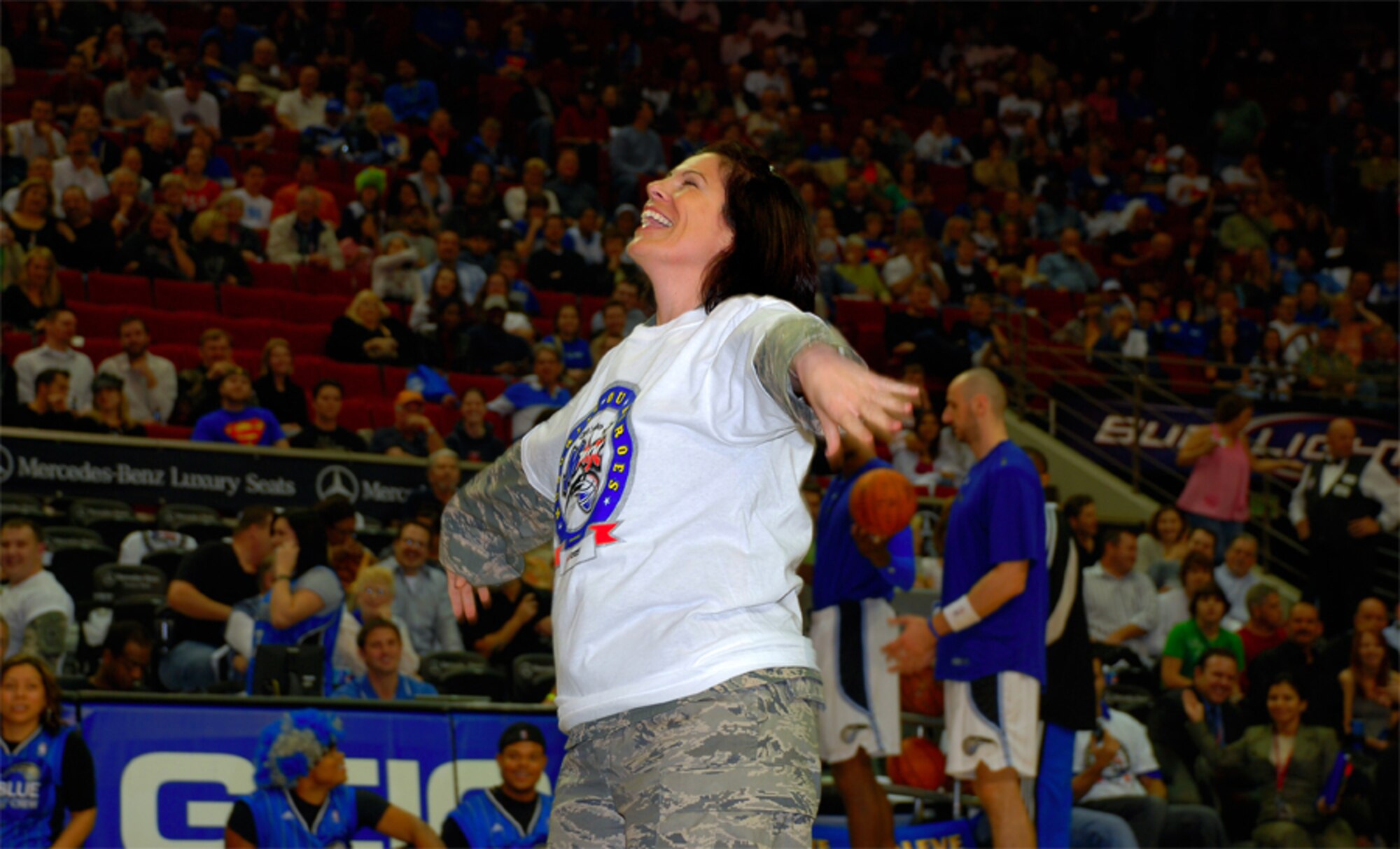 ORLANDO Fla. -- 920th Rescue Wing Reservist Staff Sgt. Diane Lopes takes part in a Simon Sez competition featuring a group of servicemembers during halftime of the Orlando Magic game.  The competition ended in a stalemate, with Sergeant Lopes and a Soldier sharing first prize. U.S. Air Force photo/Master Sgt. Bryan Ripple