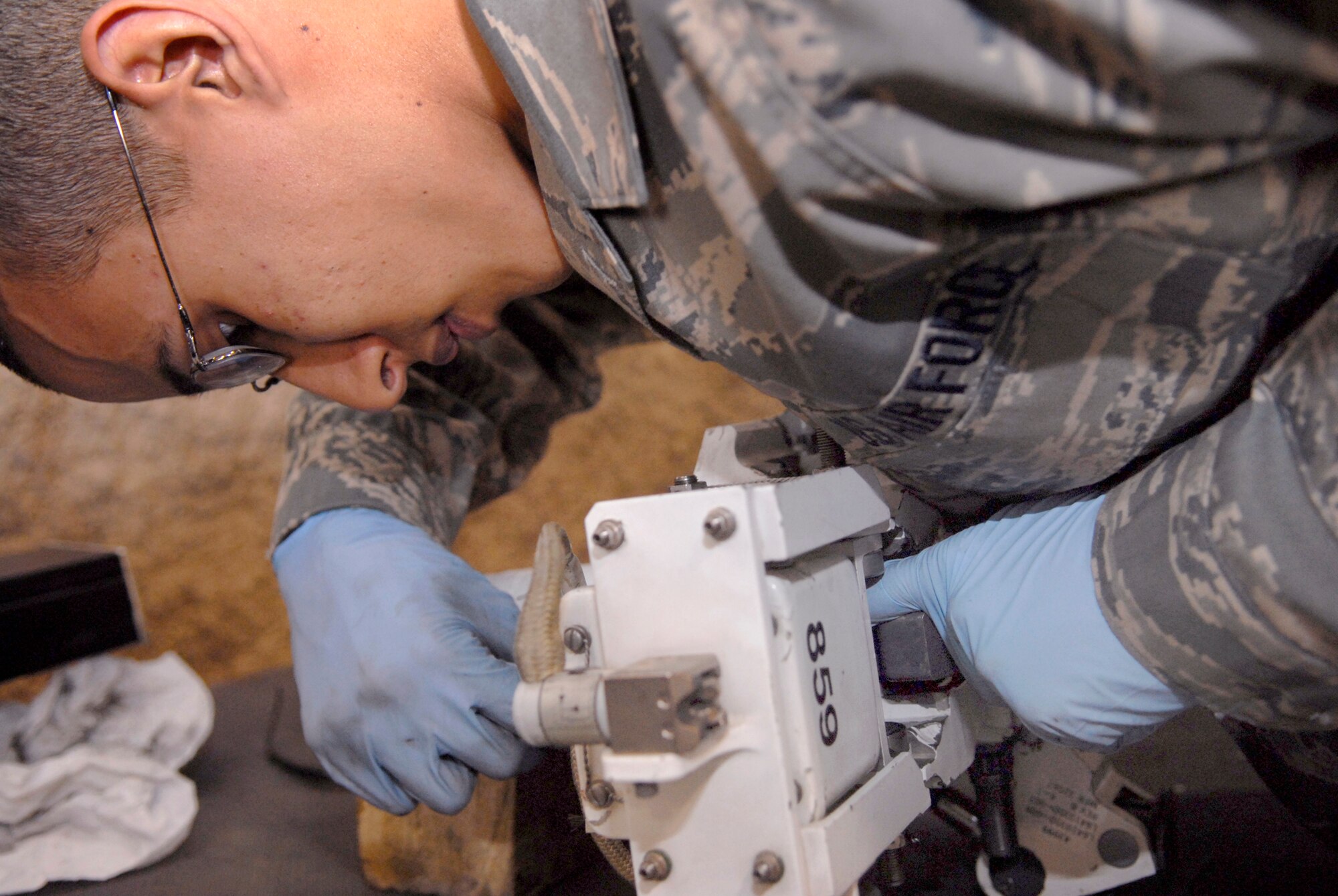 Senior Airman Diego Contreras, a 379th Expeditionary Maintenance Squadron Armament Team Member, makes a final check before the BRU-56 30 inch bomb rack is returned back to the Multi-Purpose Rotary Launcher (MPRL) off a B-1B Lancer, Feb. 6, 2009, at an undisclosed location in Southwest Asia.  Senior Airman Contreras hails from Lexington, Ky. and is deployed from Dyess Air Force Base, Texas in support of Operation Iraqi and Enduring Freedom and Combined Joint Task Force- Horn of Africa.  (U.S. Air Force Photo by Airman 1st Class Andrew Satran/Released)