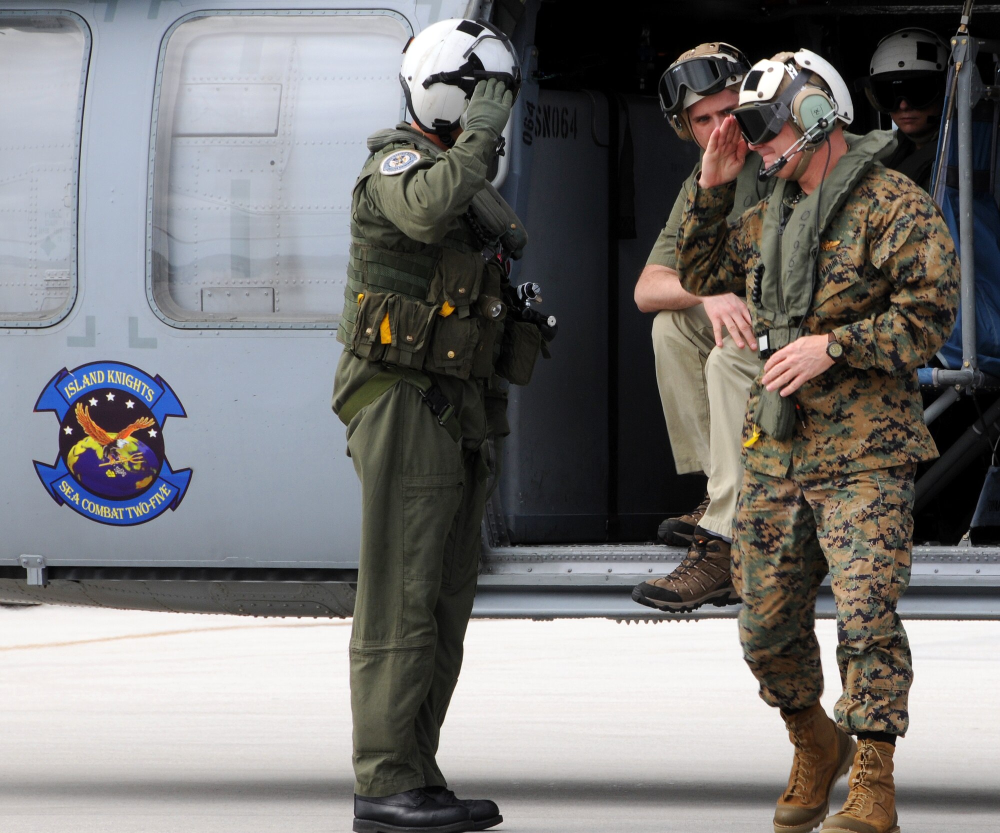 ANDERSEN AIR FORCE BASE, Guam - U.S. Navy Aviation Warfare Systems Operator 2nd Class Daniel Farnham salutes Vice Chairman of the Joint Chiefs of Staff U.S. Marine Gen. James E. Cartwright after exiting an MH-60 Knighthawk here Feb. 7. Sailors from Helicopter Sea Combat Squadron Two Five ?Island Knights? gave General Cartwright a bird?s-eye view of the island during his visit here. The vice chairman visited Andersen to receive an operational update on the military forces based on Guam and the status of plans for moving Marines from Okinawa, Japan, to Guam. (U.S. Air Force photo by Airman 1st Class Courtney Witt)(released)


