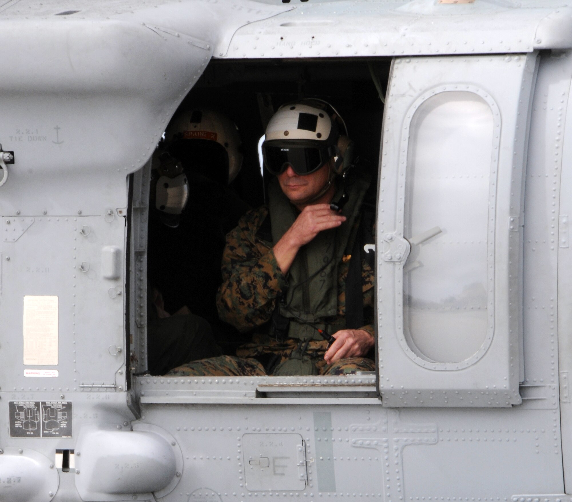 ANDERSEN AIR FORCE BASE, Guam - Vice Chairman of the Joint Chiefs of Staff U.S. Marine Gen. James E. Cartwright communicates with an Helicopter Sea Combat Squadron Two Five MH-60 Knighthawk pilot here following a helicopter tour over the island Feb. 7. General Cartwright visited Andersen to receive an operational update on the military forces based on Guam and the status of plans for moving Marines from Okinawa, Japan, to Guam. (U.S. Air Force photo by Airman 1st Class Courtney Witt)(released)