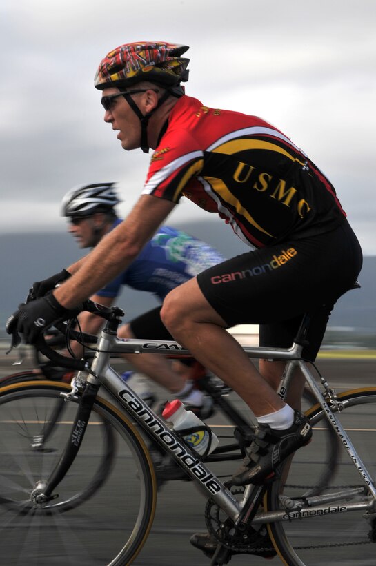 A competitor in the Marine Corps Air Facility Criterium::r::::n::Bike Race pedals through the 0.08-mile oval loop course::r::::n::held at the approach-end of Runway 22 on the Marine::r::::n::Corps Base Hawaii flight line Feb. 8.