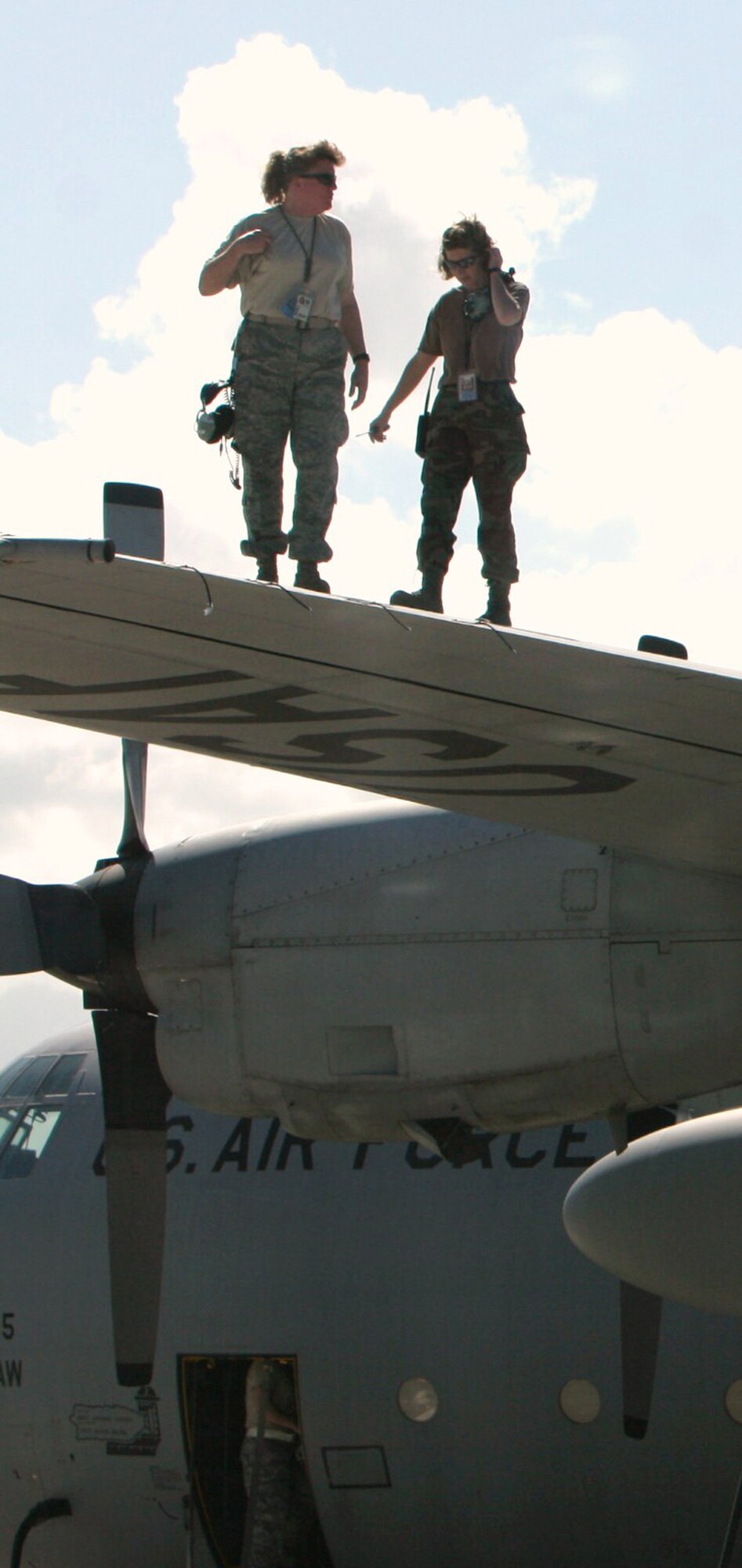 Senior Master Sgt. Kim Robinson (left) and 1st Lt. Sharon Rice perform a visual inspection of a C-130 Hercules wing Dec. 12, 2008, before the aircraft's next mission at Muniz Air National Guard Base in Puerto Rico. Both Airmen were deployed with members of the 302nd Airlift Wing in support of Operation Coronet Oak, a U.S. Southern Command-supported mission encompassing several missions, including the resupply of U.S. embassies, medical evacuation and support for U.S. troops in the region. (U.S. Air Force photo/Master Sgt. Heldwin Brito)